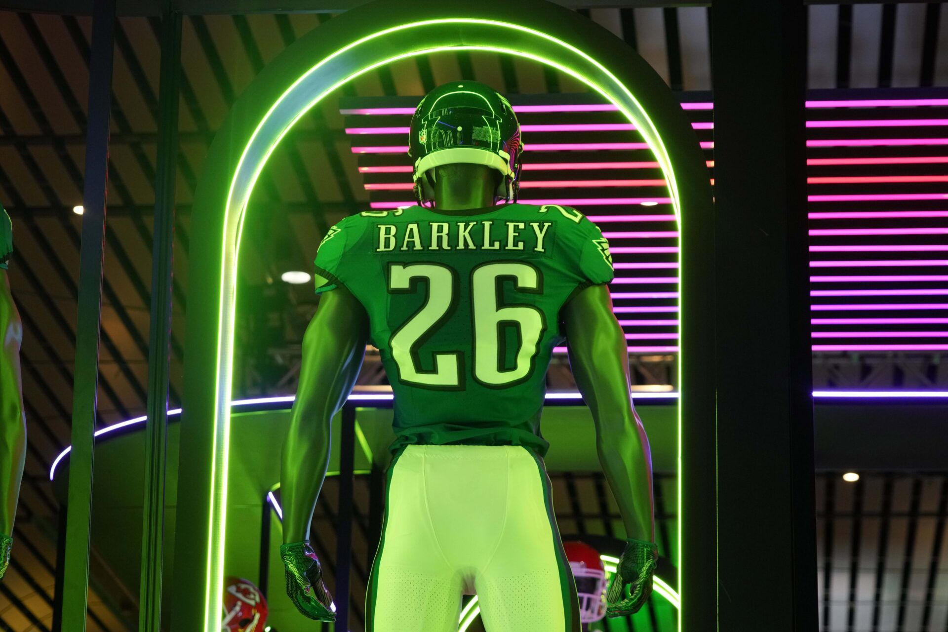 A Nike football display featuring the uniform and helmet of Philadelphia Eagles running back Saquon Barkley (26) at the NFL Shop at the Super Bowl LIX Experience at the Ernest N. Morial Convention Center.