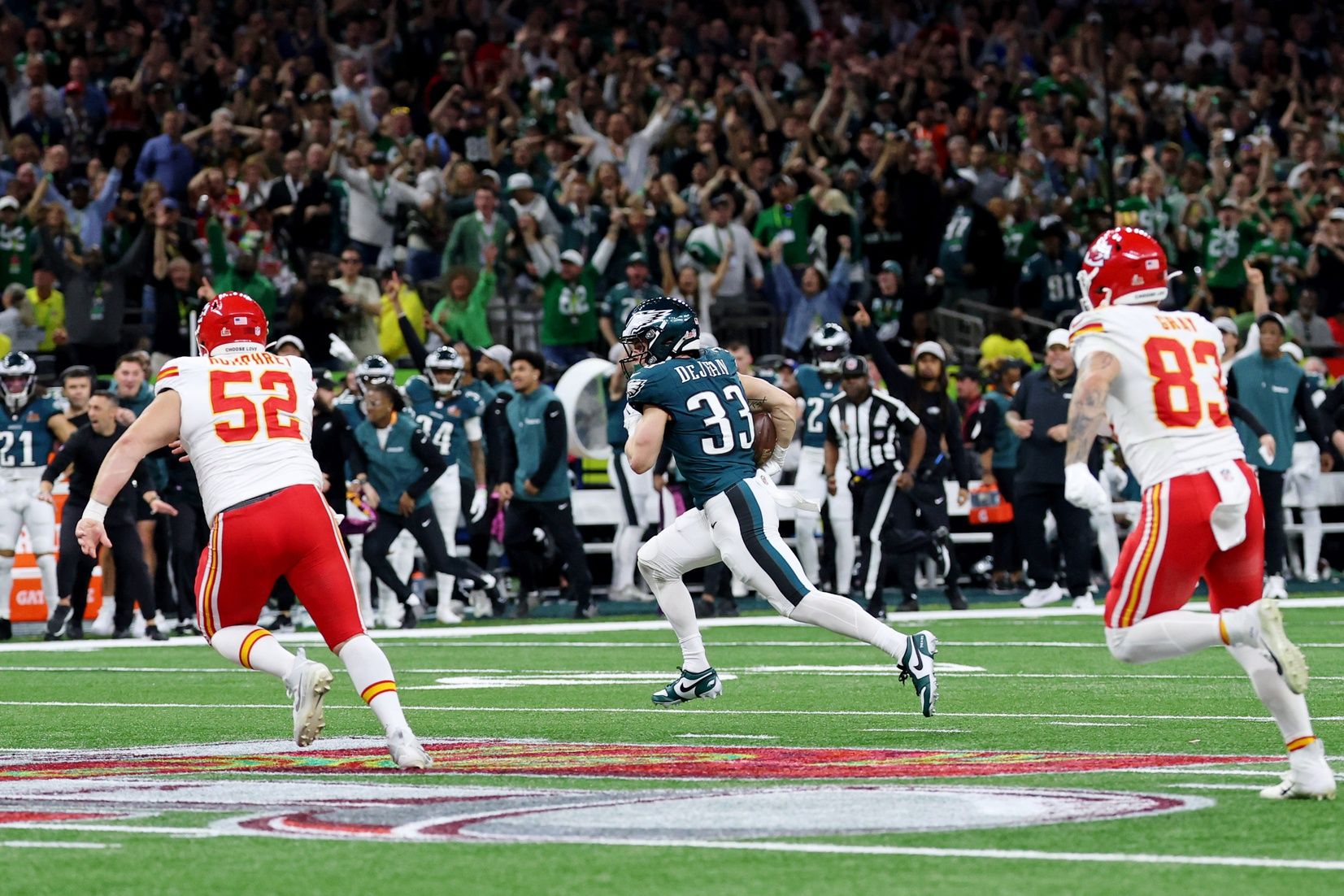 Philadelphia Eagles cornerback Cooper DeJean (33) runs with the ball after making an interception against the Kansas City Chiefs during the first half of Super Bowl LIX at Caesars Superdome.