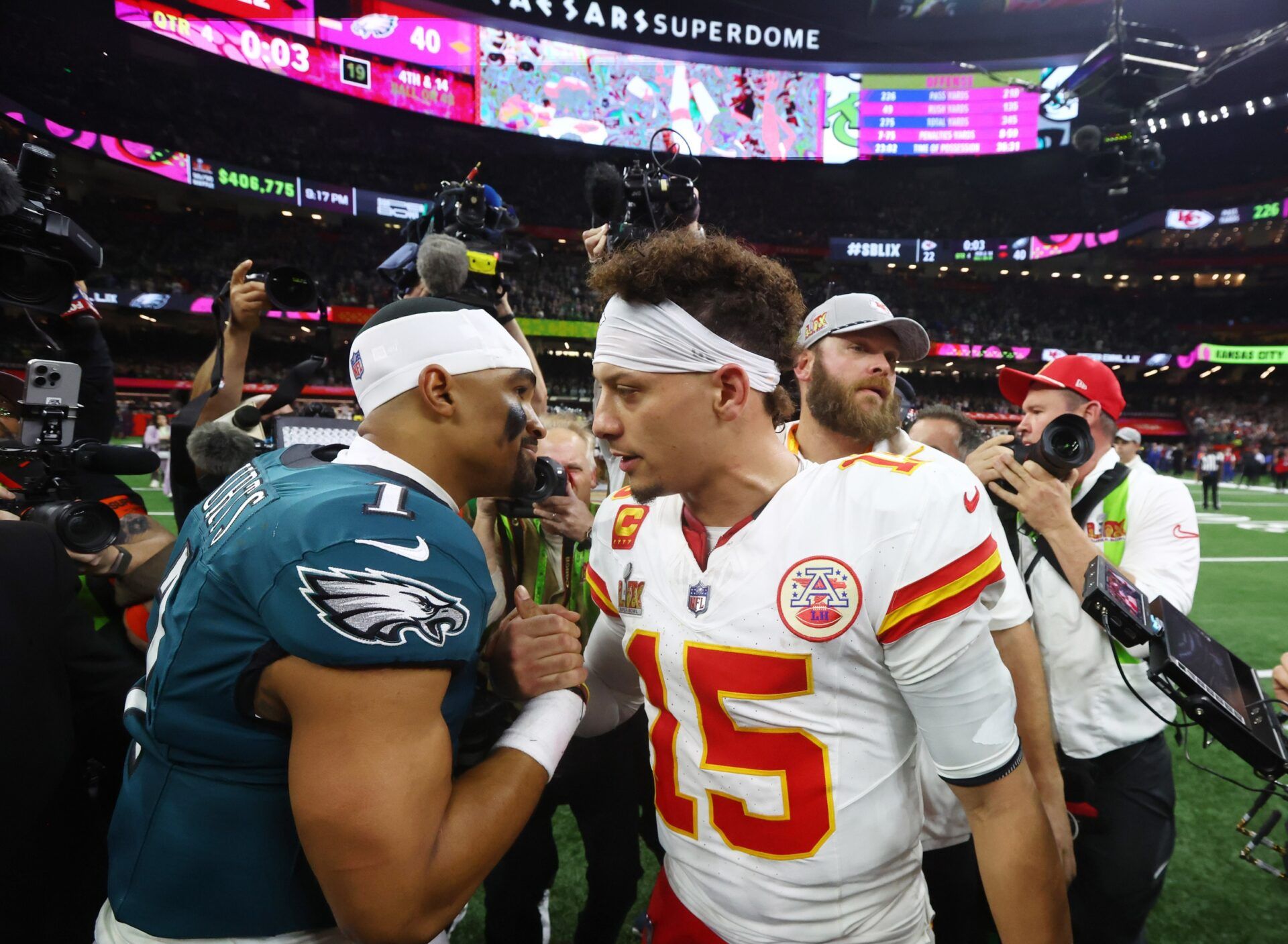 Philadelphia Eagles quarterback Jalen Hurts (1) shakes hands with Kansas City Chiefs quarterback Patrick Mahomes (15) after Super Bowl LIX at Ceasars Superdome.