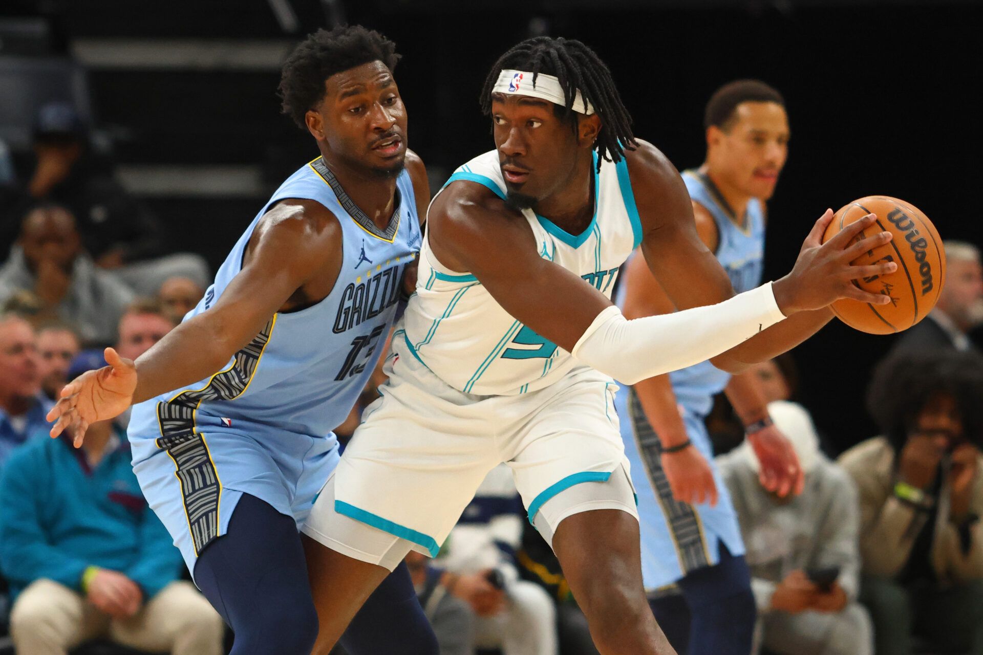 Jan 22, 2025; Memphis, Tennessee, USA; Charlotte Hornets center Mark Williams (5) handles the ball as Memphis Grizzlies forward Jaren Jackson Jr. (13) defends during the third quarter at FedExForum. Mandatory Credit: Petre Thomas-Imagn Images