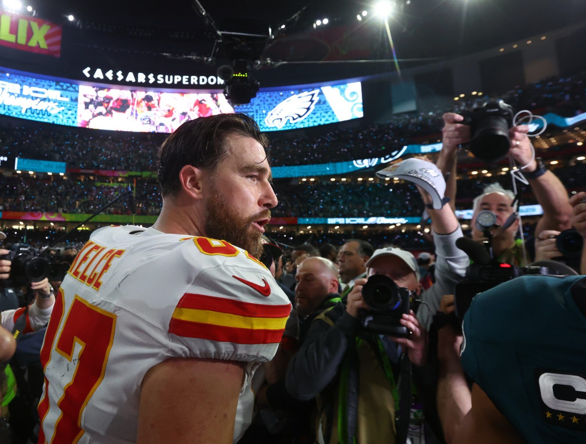 Kansas City Chiefs tight end Travis Kelce (87) reacts on the field after losing to the Philadelphia Eagles in Super Bowl 59 at Caesars Superdome.