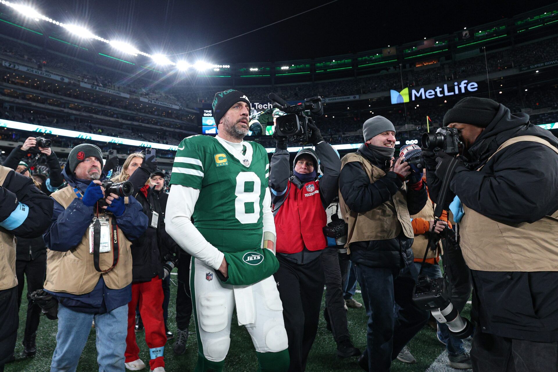 New York Jets quarterback Aaron Rodgers (8) walks on the field after the game against the Miami Dolphins at MetLife Stadium.