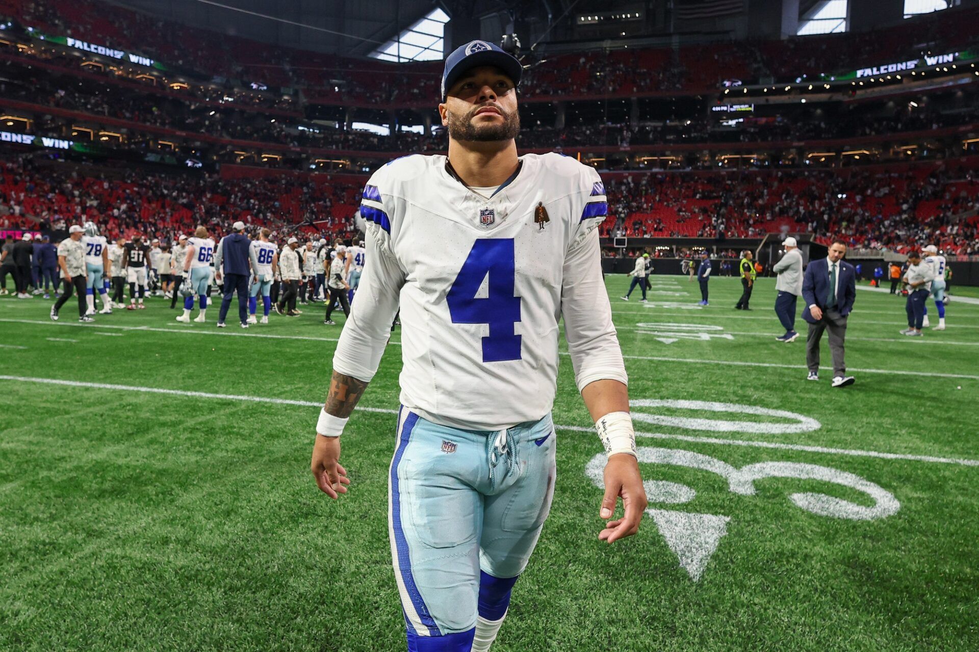 Dallas Cowboys quarterback Dak Prescott (4) walks off the field after a game against the Atlanta Falcons at Mercedes-Benz Stadium.