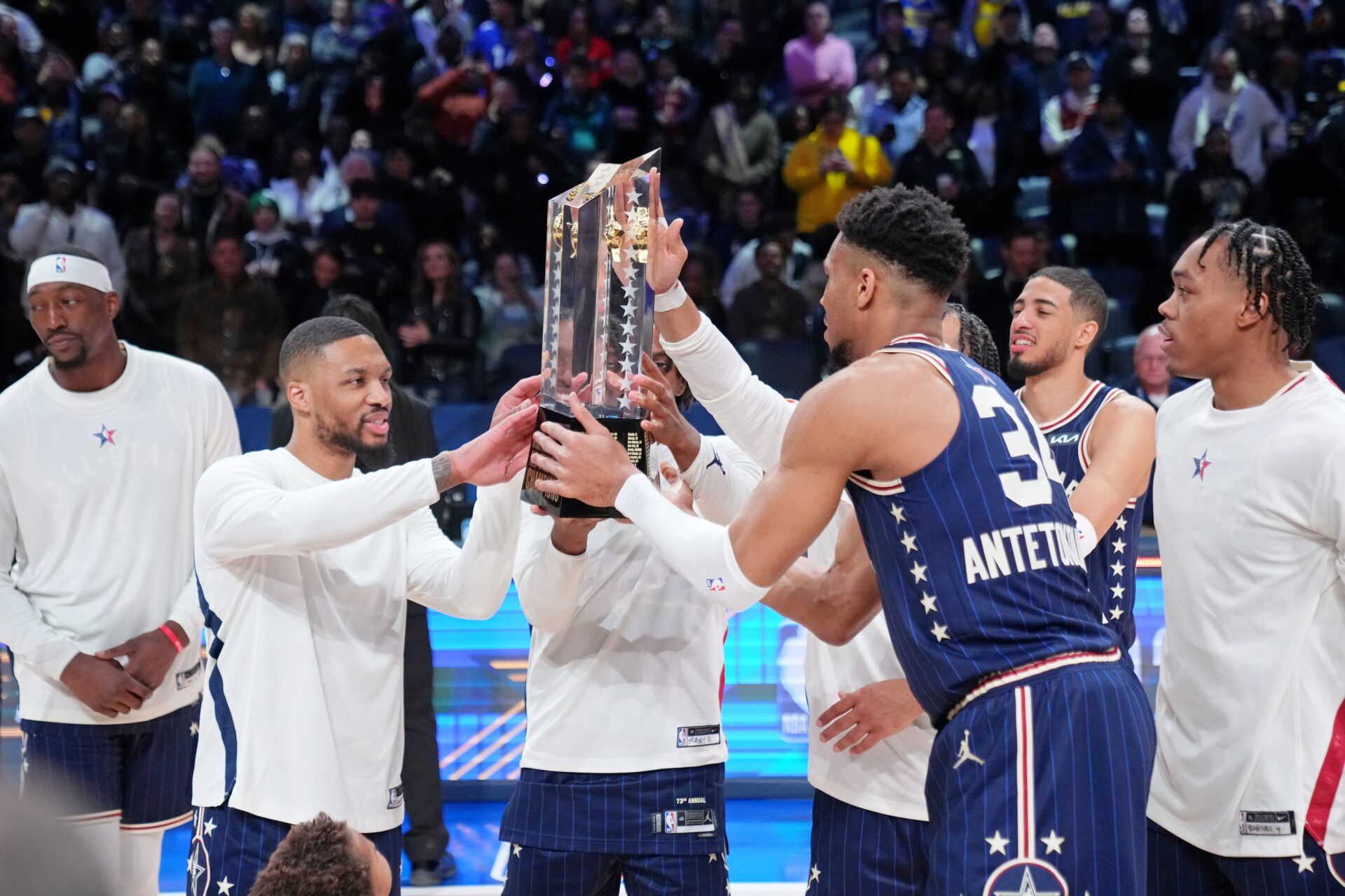 Eastern Conference guard Damian Lillard (left) of the Milwaukee Bucks and forward Giannis Antetokounmpo (34) of the Milwaukee Bucks hold the trophy after winning the 73rd NBA All Star game at Gainbridge Fieldhouse.