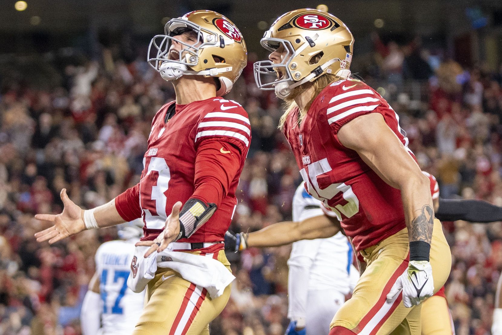 San Francisco 49ers quarterback Brock Purdy (13) celebrates with tight end George Kittle (85) after scoring a touchdown against the Detroit Lions during the second quarter at Levi's Stadium.