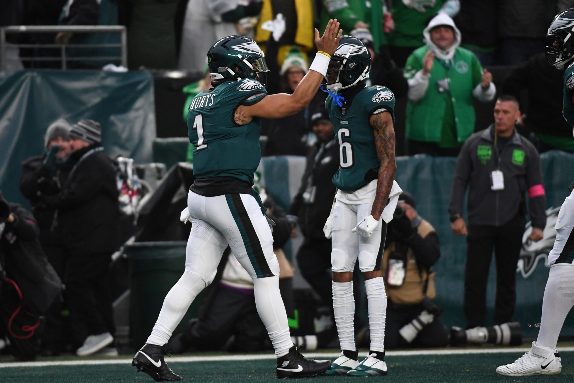 Philadelphia Eagles quarterback Jalen Hurts (1) celebrate with Eagles wide receiver DeVonta Smith (6) after scoring a touchdown against the Los Angeles Rams in the first half in a 2025 NFC divisional round game at Lincoln Financial Field.