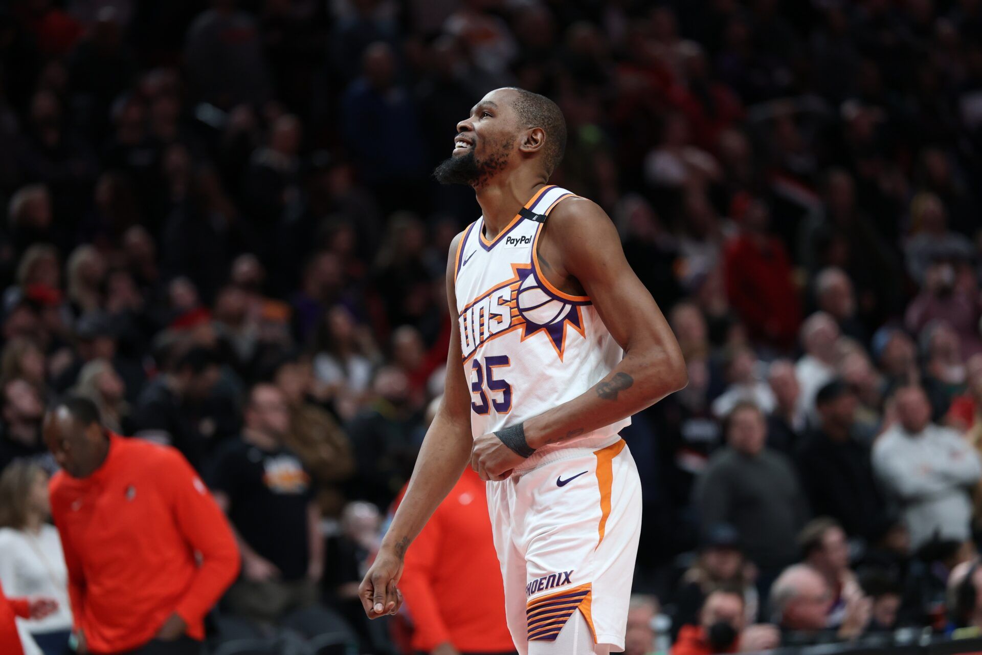 Phoenix Suns forward Kevin Durant (35) laughs as he watches a replay of his teammate SunsÕ guard Devin Booker (1) being fouled by Portland Trail Blazers forward Deni Avdija (8) in overtime at Moda Center.