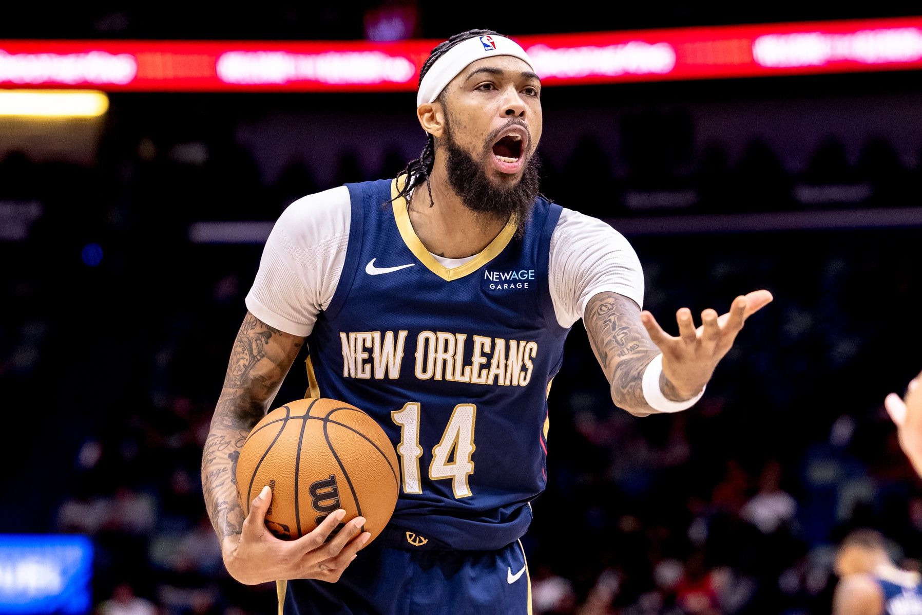 New Orleans Pelicans forward Brandon Ingram (14) reacts to a play against Phoenix Suns guard Devin Booker (1) during the first half at Smoothie King Center.