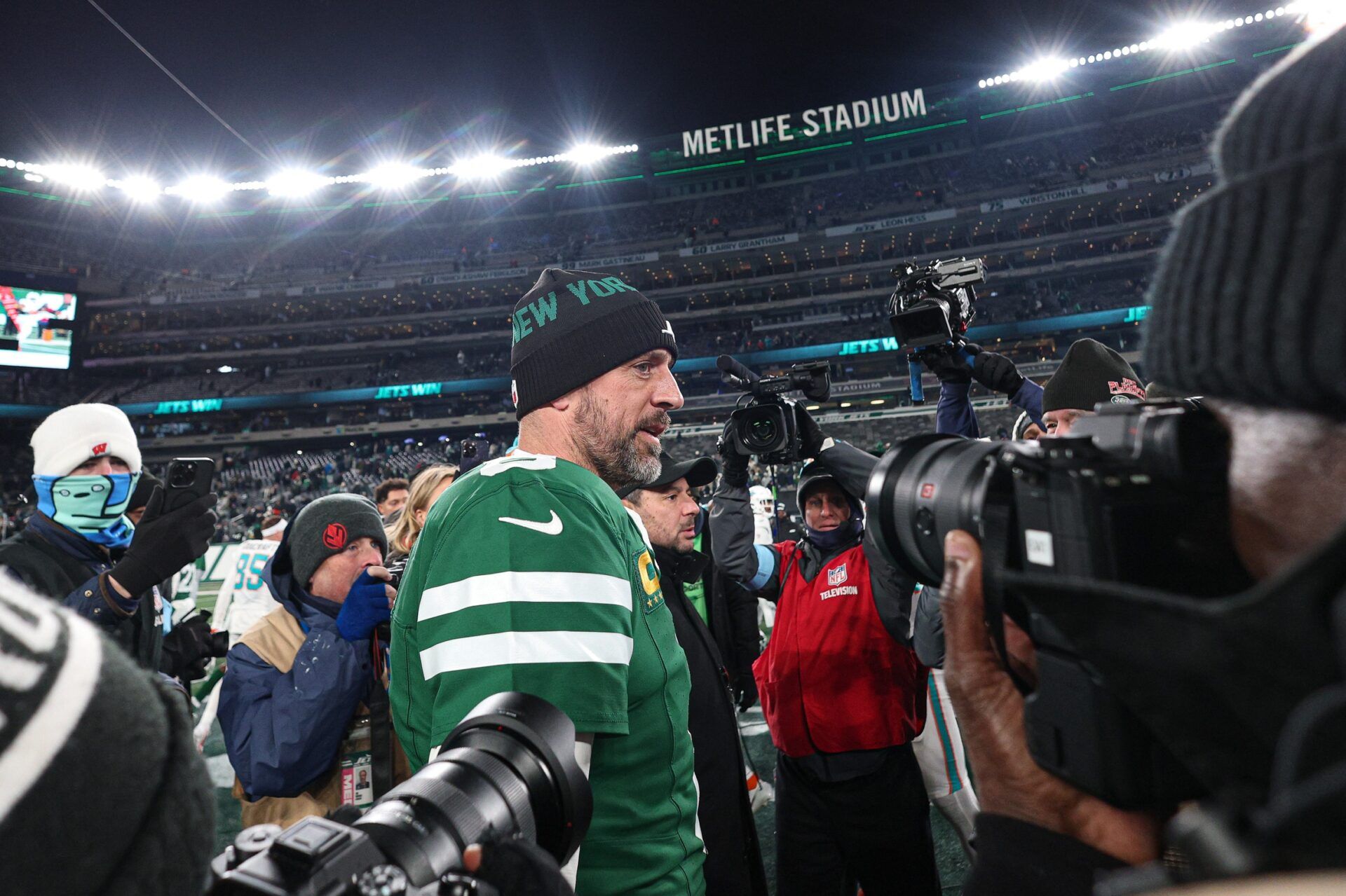 New York Jets quarterback Aaron Rodgers (8) walks on the field after the game against the Miami Dolphins at MetLife Stadium.