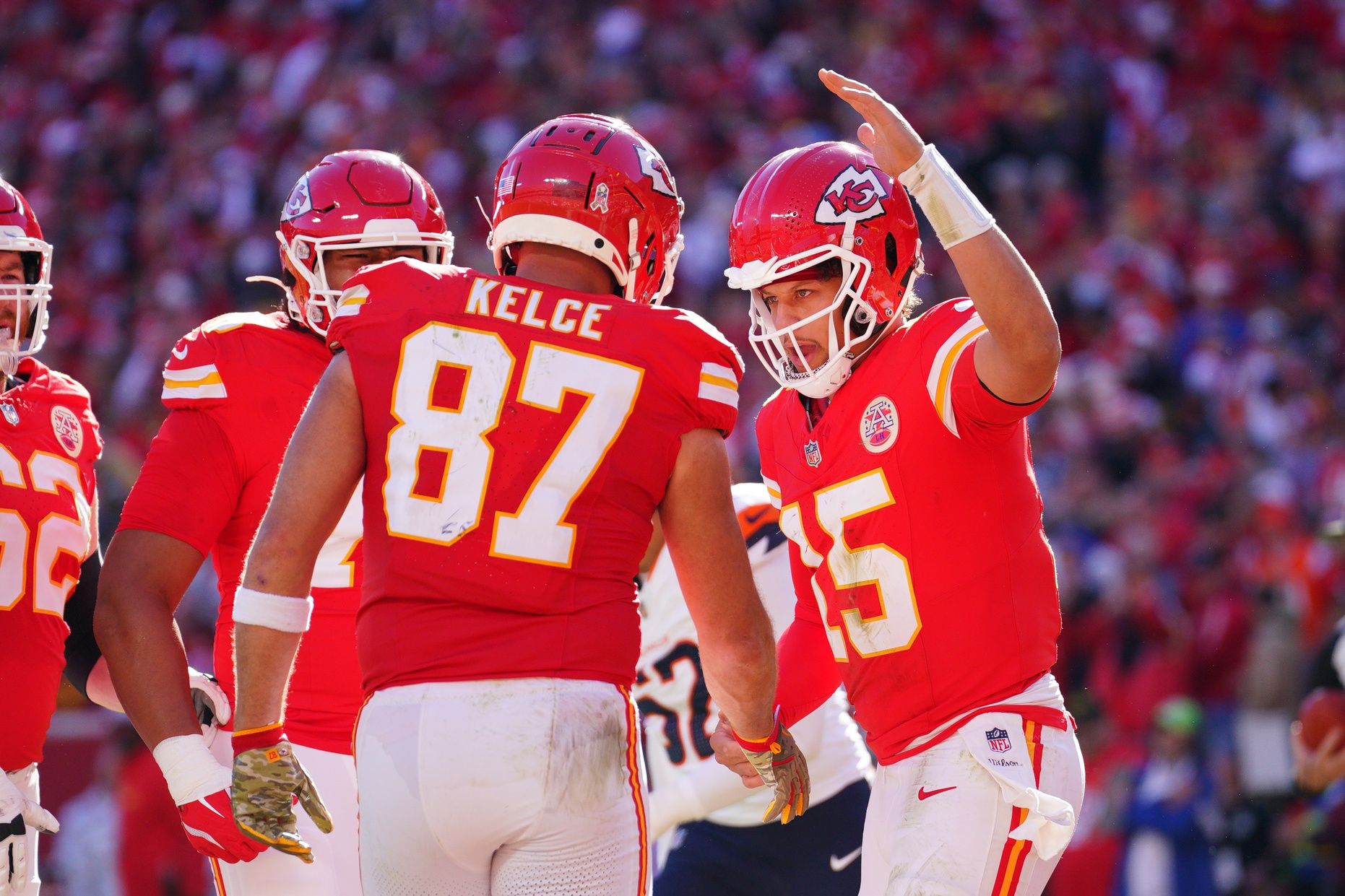 Kansas City Chiefs tight end Travis Kelce (87) celebrates with quarterback Patrick Mahomes (15) after scoring against the Denver Broncos during the first half at GEHA Field at Arrowhead Stadium.