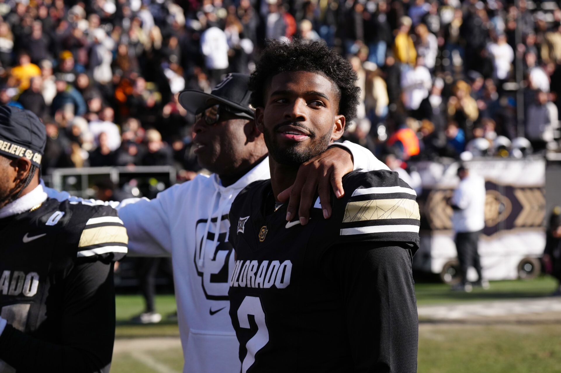 Nov 29, 2024; Boulder, Colorado, USA; Colorado Buffaloes quarterback Shedeur Sanders (2) and head coach Deion Sanders ifollowing the win over the Oklahoma State Cowboys at Folsom Field. Mandatory Credit: Ron Chenoy-Imagn Images