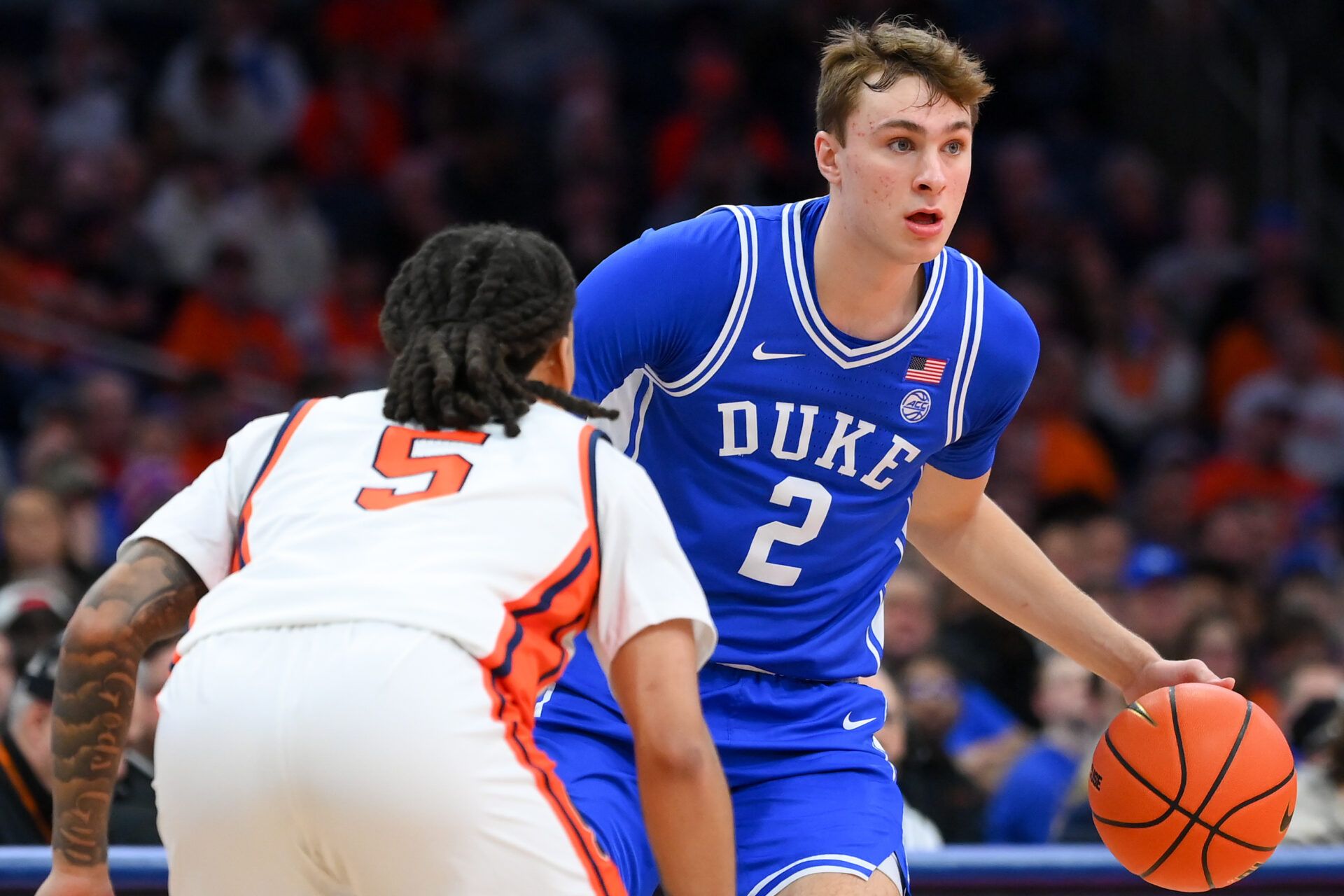 Feb 5, 2025; Syracuse, New York, USA; Duke Blue Devils guard Cooper Flagg (2) controls the ball as Syracuse Orange guard Jaquan Carlos (5) defends during the first half at the JMA Wireless Dome. Mandatory Credit: Rich Barnes-Imagn Images