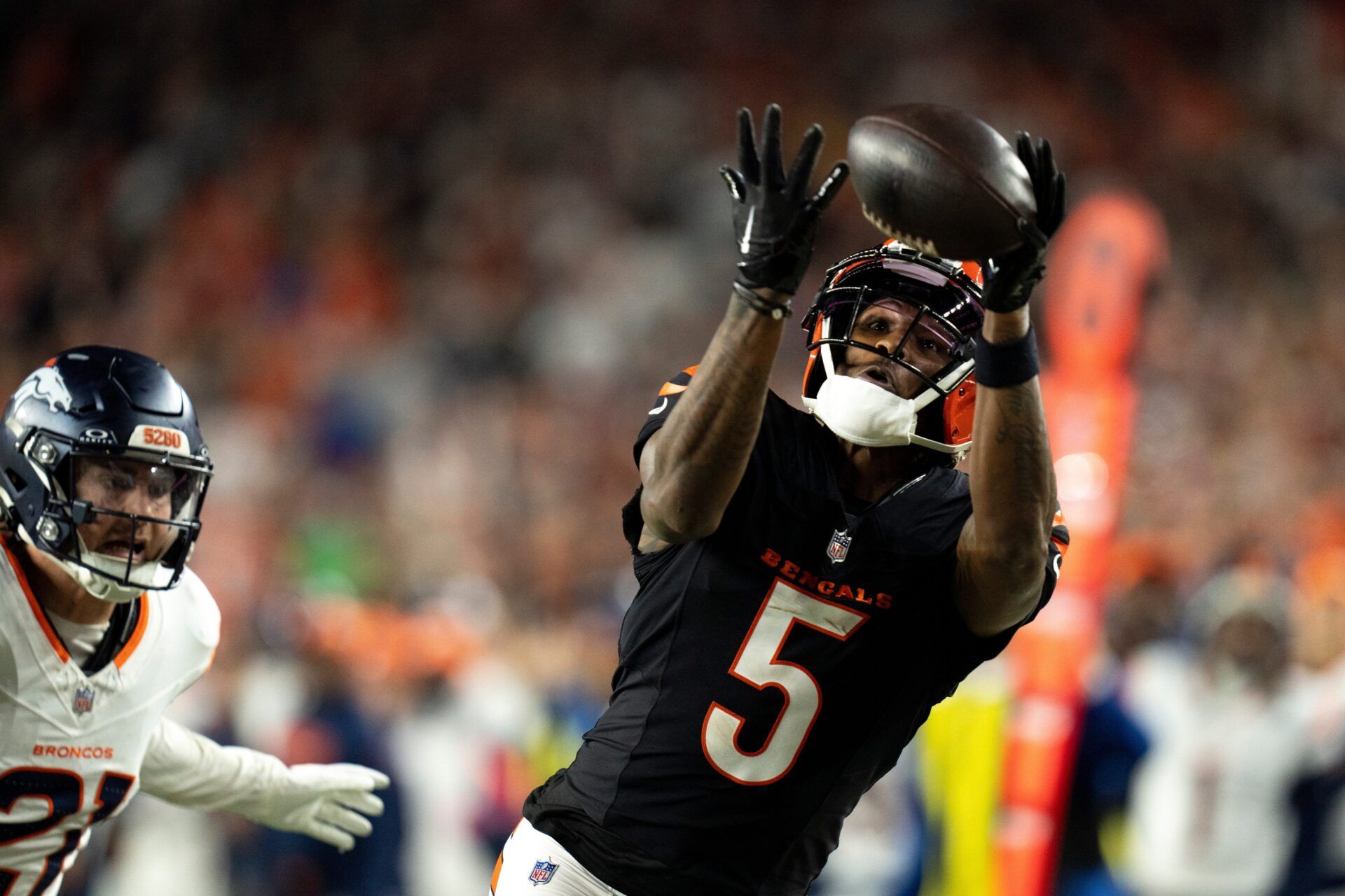 Cincinnati Bengals wide receiver Tee Higgins (5) catches a pass inside the 5-yard line as Denver Broncos cornerback Riley Moss (21) defends in overtime of the NFL game at Paycor Stadium in Cincinnati on Saturday, Dec. 28, 2024.