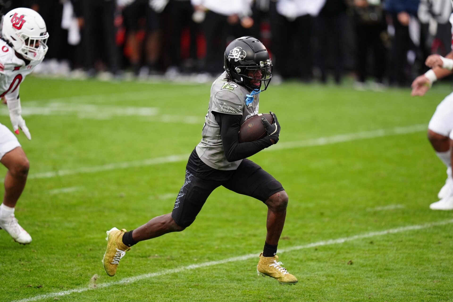 Colorado Buffaloes wide receiver Travis Hunter (12) carries for a touchdown in the fourth quarter against the Utah Utes at Folsom Field.