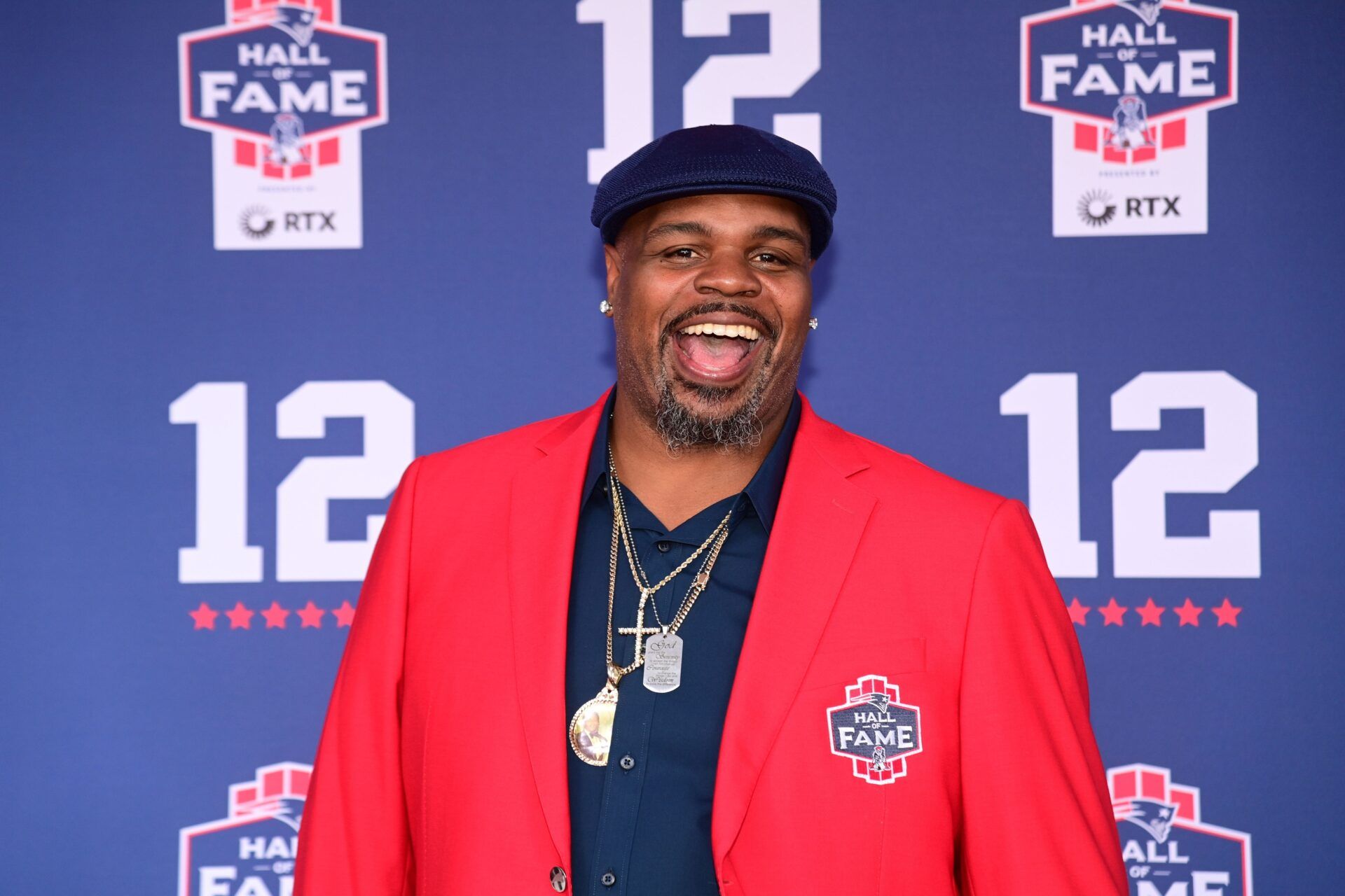 Former NFL player Vince Wilfork stops on the red carpet for a photo at the New England Patriots Hall of Fame induction ceremony for Tom Brady at Gillette Stadium.