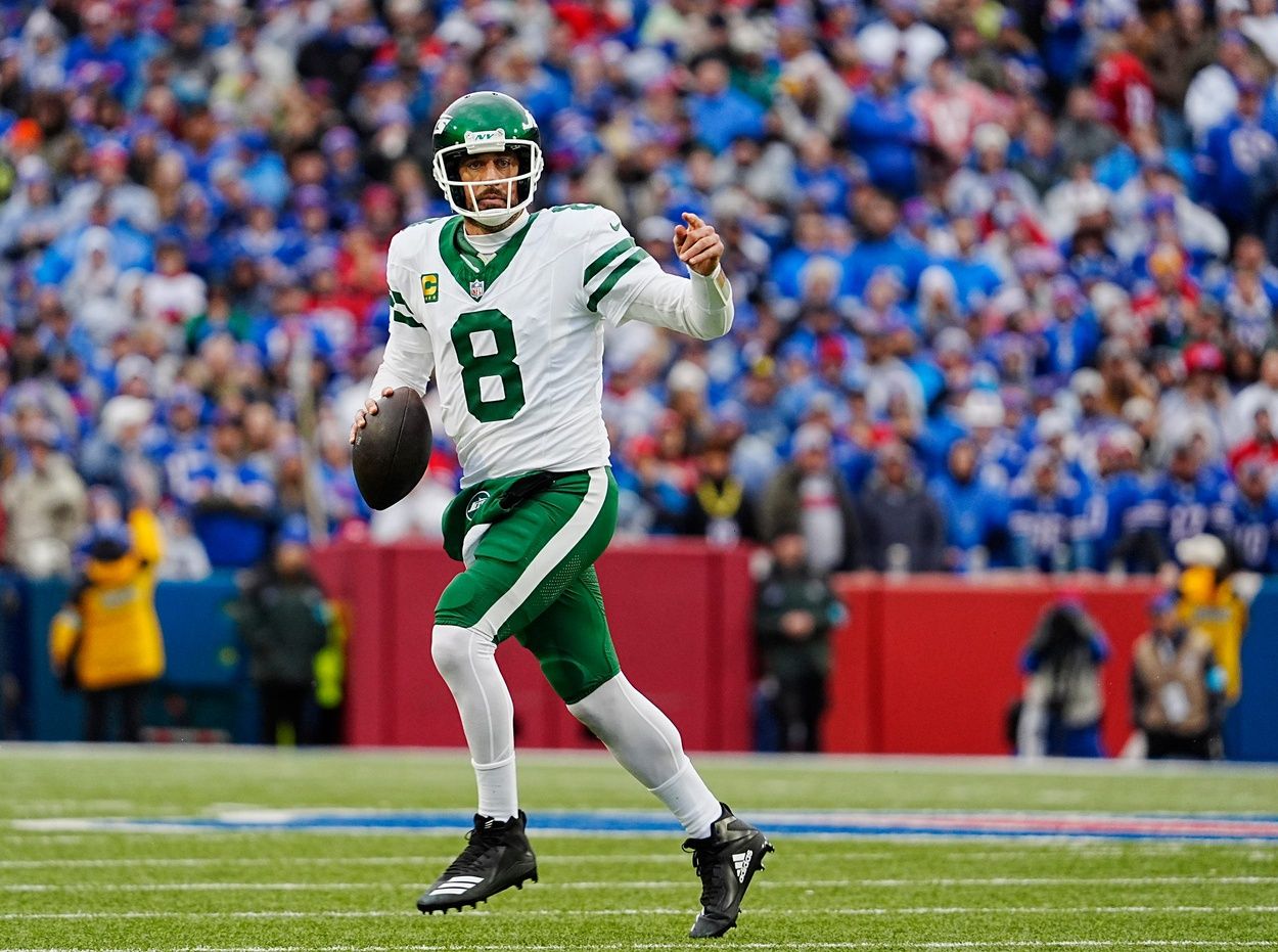 New York Jets quarterback Aaron Rodgers (8) breaks away on a fake hand-off looking for an open receiver during first half action at the Bills home game against the New York Jets at Highmark Stadium in Orchard Park on Dec. 29, 2024. His pass was incomplete.