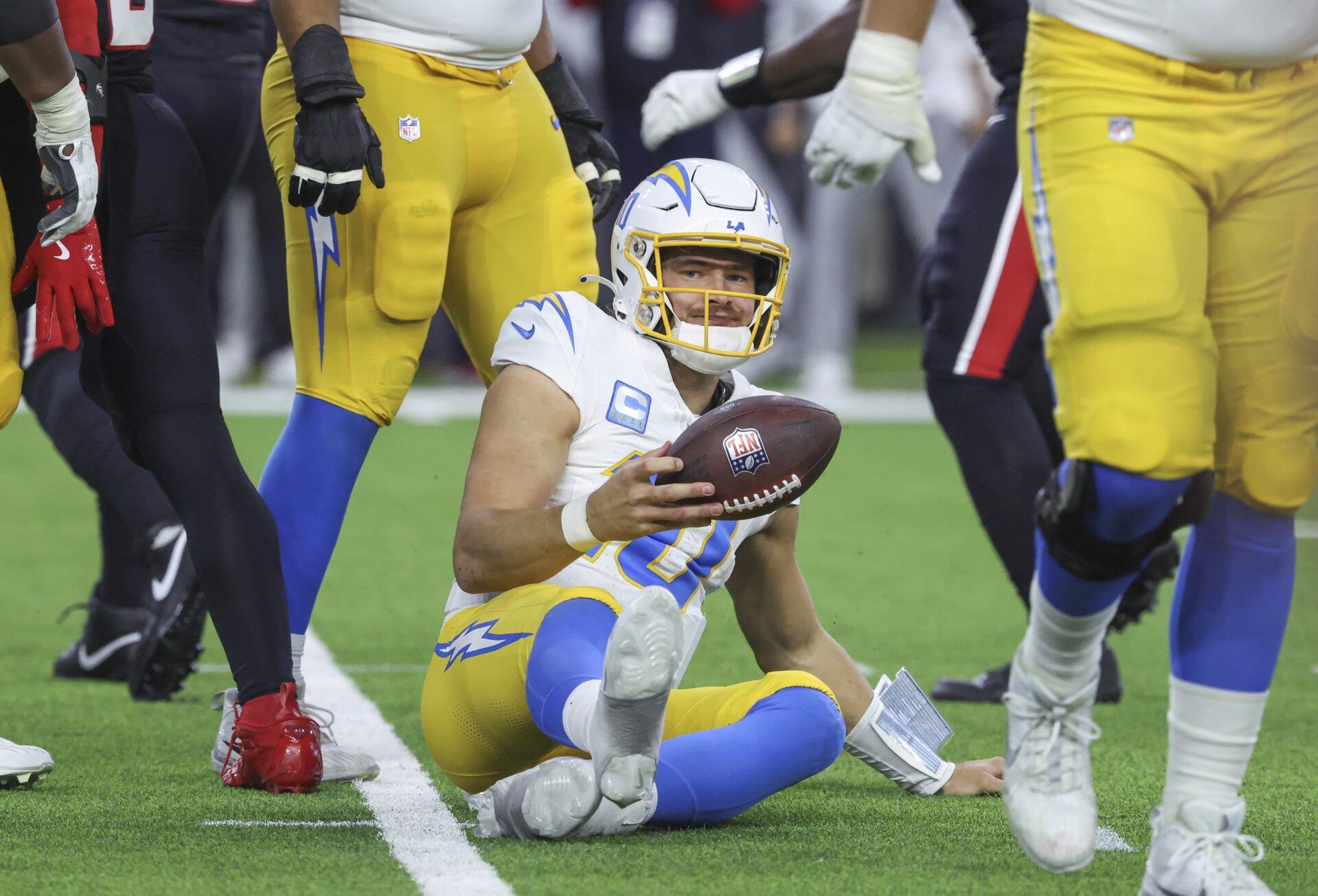 Los Angeles Chargers quarterback Justin Herbert (10) reacts after being sacked during the game against the Houston Texans in an AFC wild card game at NRG Stadium.