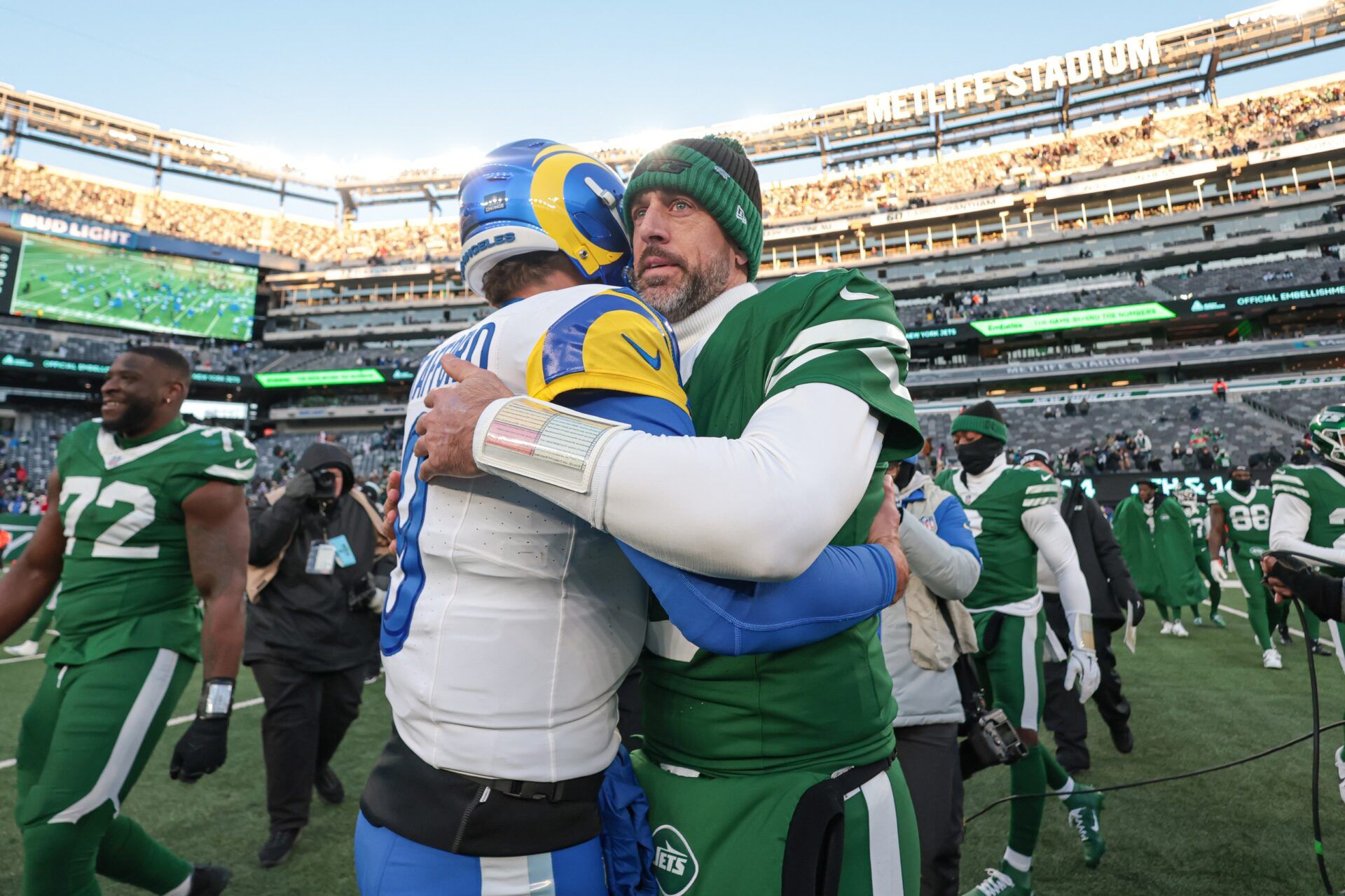 Los Angeles Rams quarterback Matthew Stafford (9) hits New York Jets quarterback Aaron Rodgers (8) after the game at MetLife Stadium.