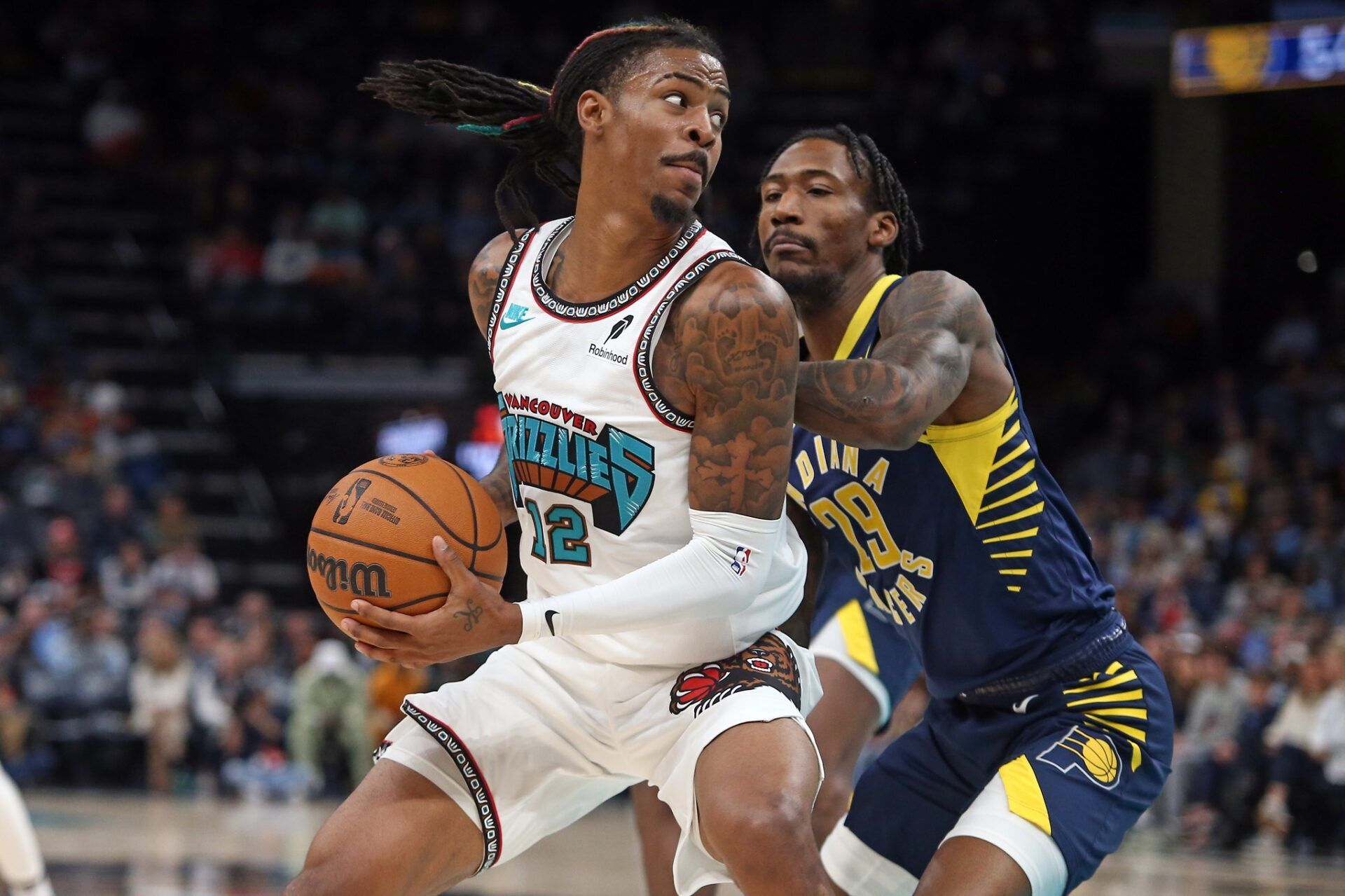 Memphis Grizzlies guard Ja Morant (12) spins toward the basket as Indiana Pacers guard Quenton Jackson (29) defends during the second quarter at FedExForum.