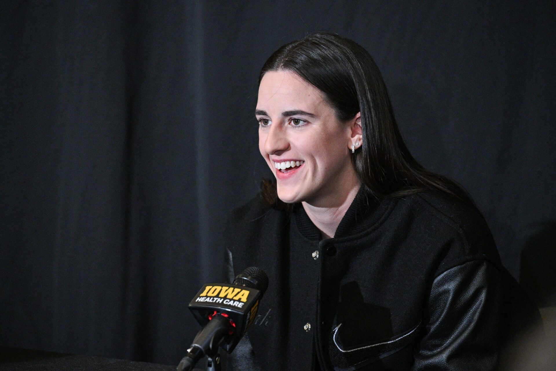 Former Iowa Hawkeyes player Caitlin Clark talks with the media before the game against the USC Trojans at Carver-Hawkeye Arena. The Hawkeyes will be retiring the jersey of Clark after the game.