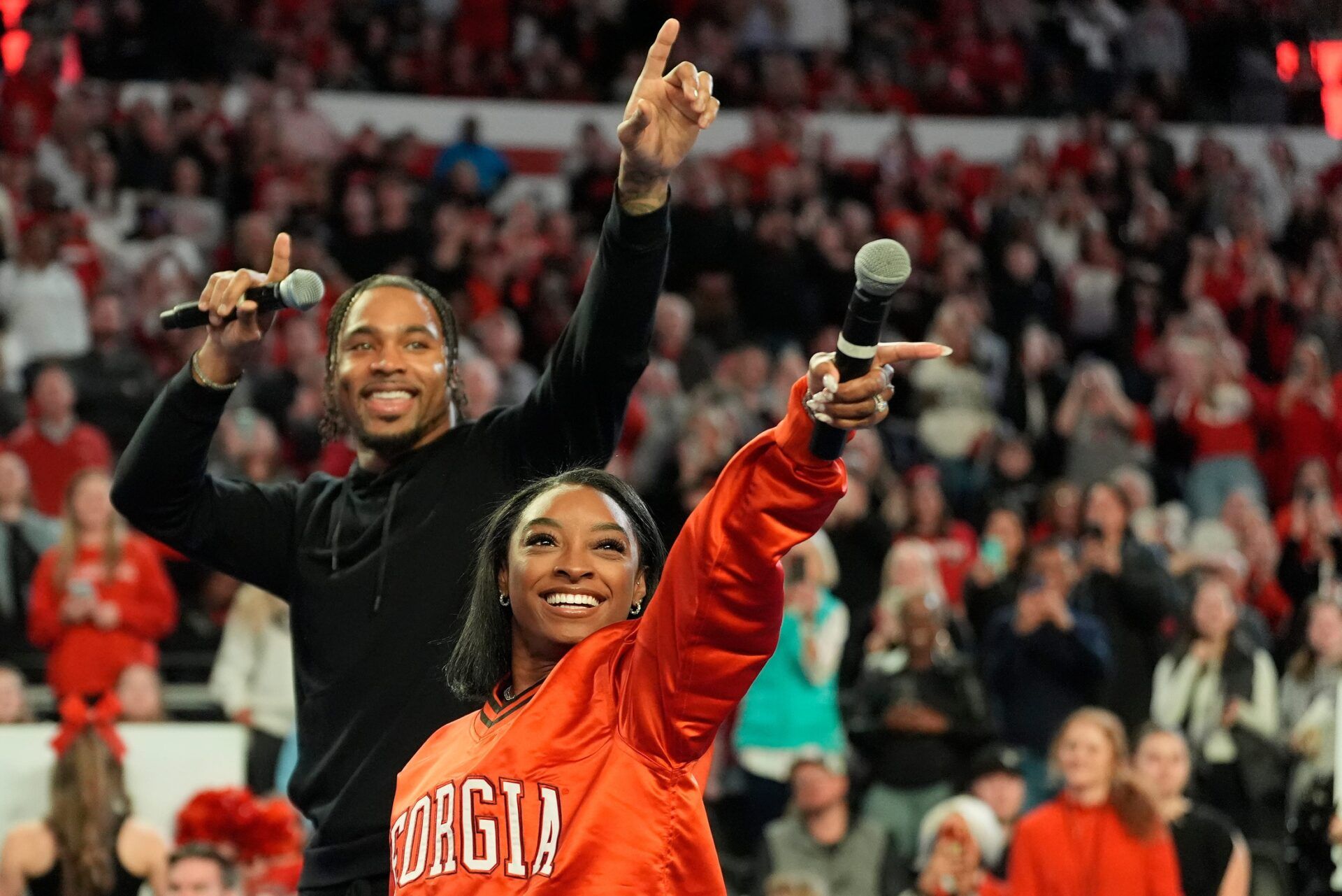 Simone Biles calls the Dawg with her husband Jonathan Owens during a NCAA gymnastics meet against Boise State in Athens, Ga., on Friday, Jan. 17, 2024.