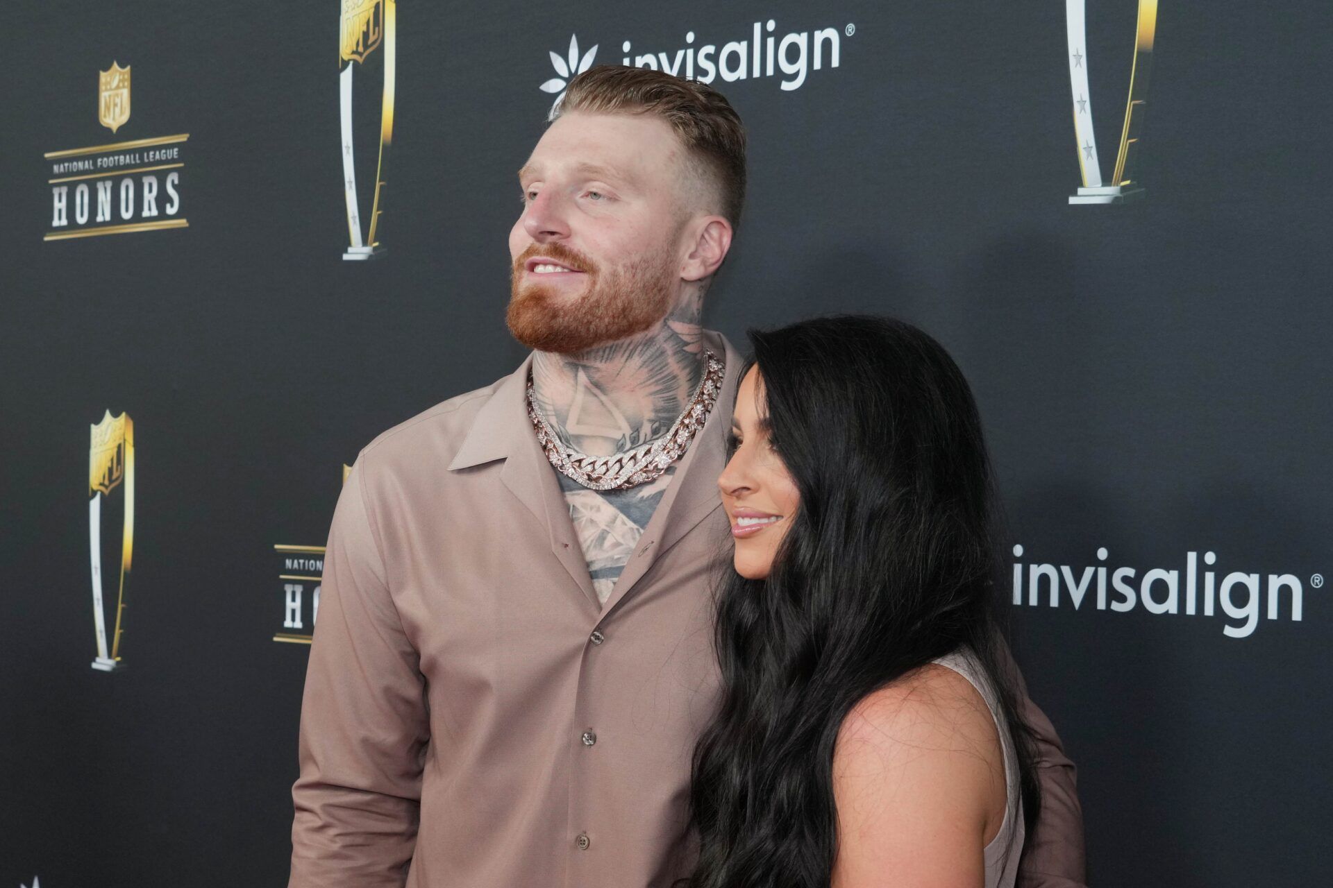 Maxx Crosby and his wife Rachel Washburn on the red carpet before Super Bowl LIX NFL Honors at Saenger Theatre.