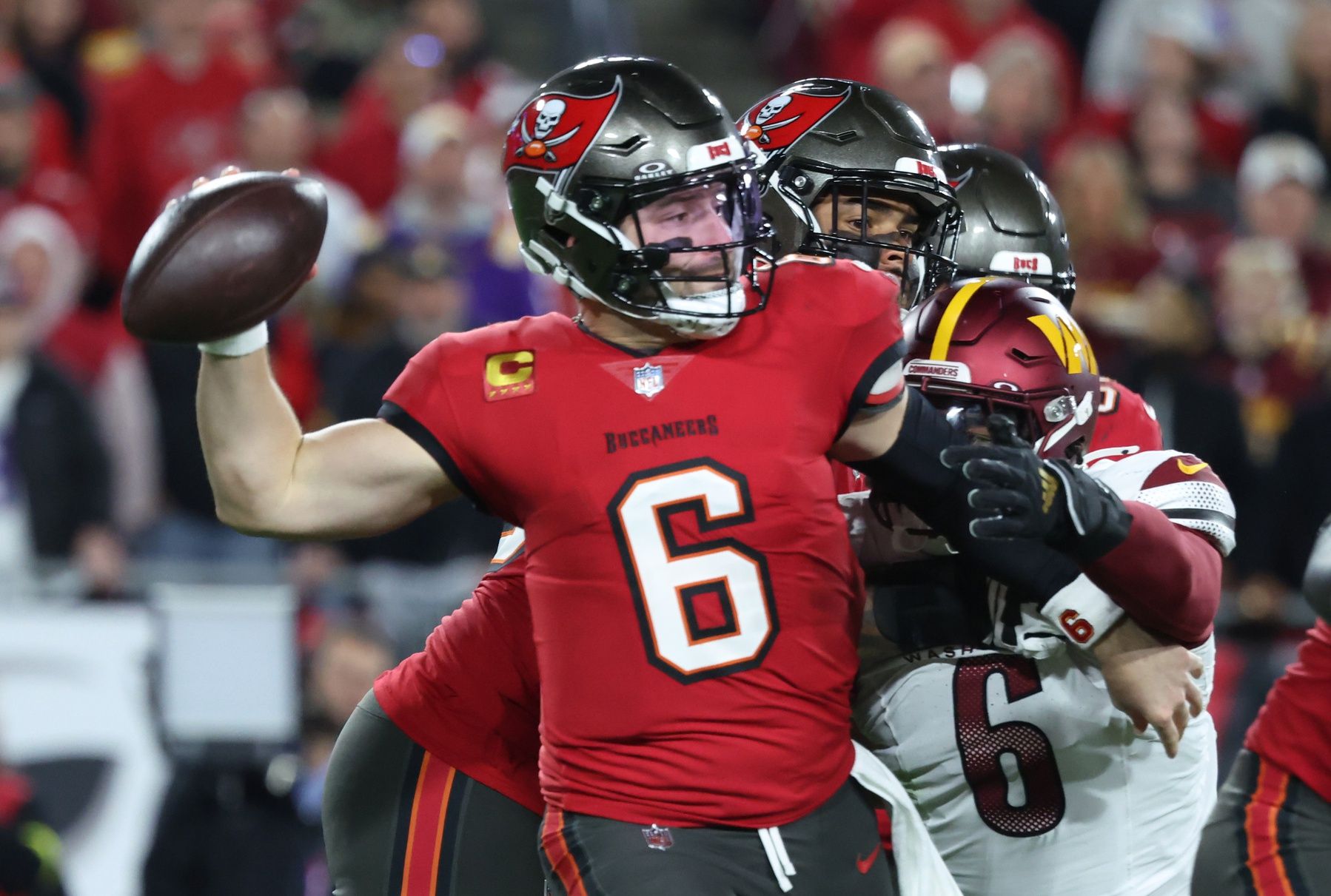 Tampa Bay Buccaneers quarterback Baker Mayfield (6) throws against Washington Commanders linebacker Dante Fowler Jr. (6) during the second quarter of a NFC wild card playoff at Raymond James Stadium.