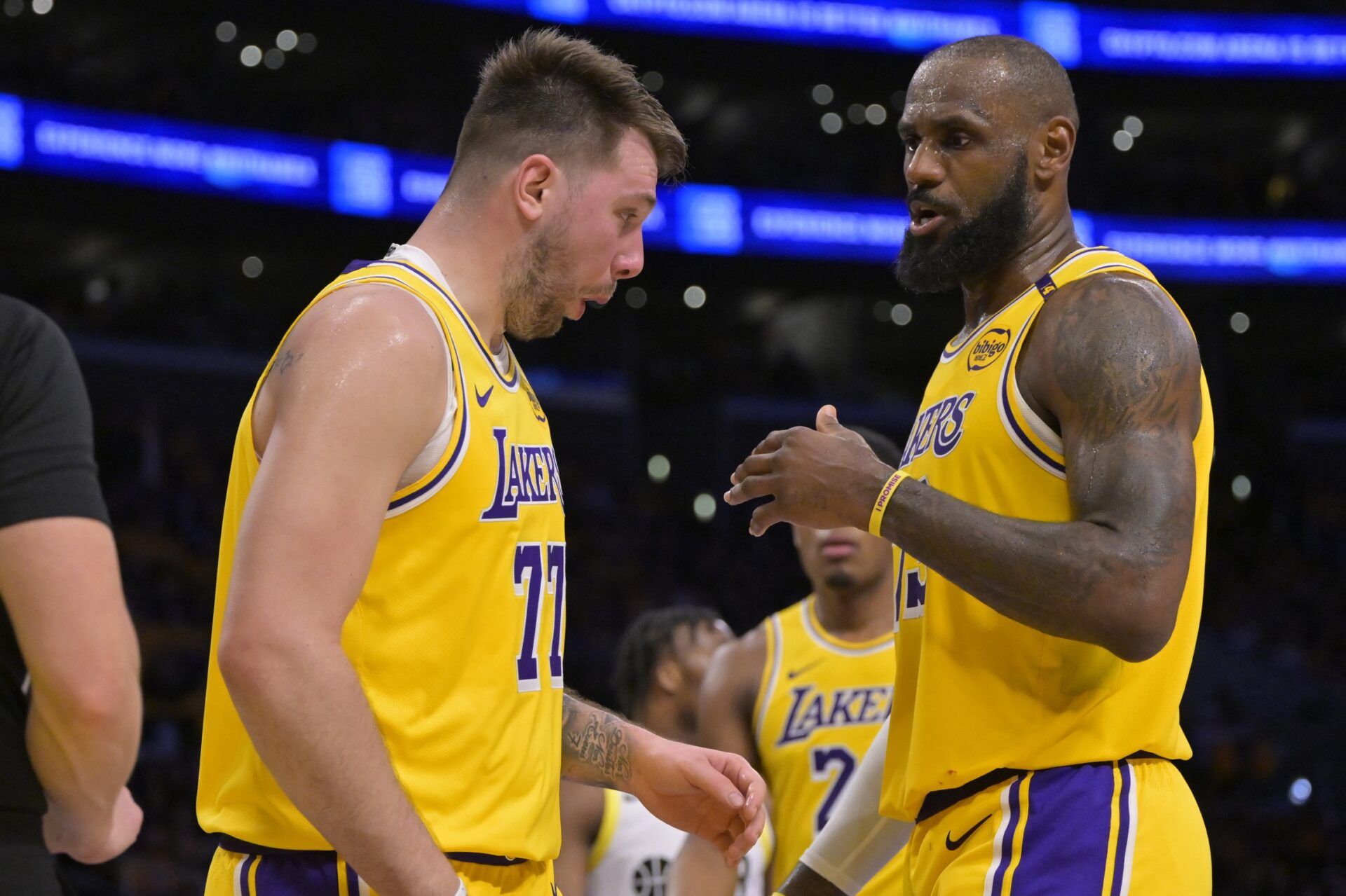 Los Angeles Lakers forward LeBron James (23) checks on guard Luka Doncic (77) after he was hit in the face against the Utah Jazz at Crypto.com Arena.