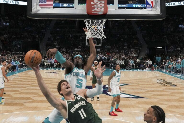 Charlotte Hornets center Mark Williams (5) blocks a shot by Milwaukee Bucks center Brook Lopez (11) during the second half at Spectrum Center.