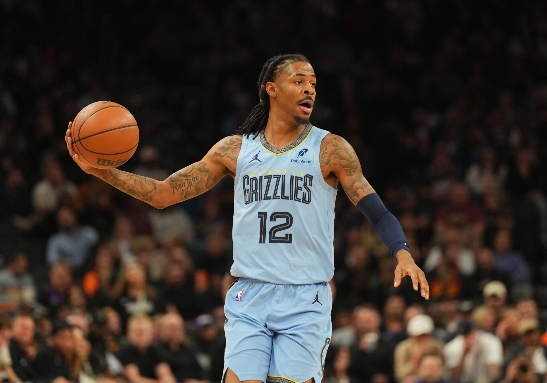 Memphis Grizzlies guard Ja Morant (12) controls the ball against the Phoenix Suns during the second half at Footprint Center.