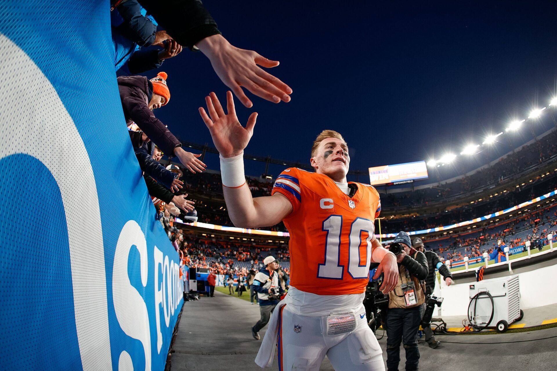 Denver Broncos quarterback Bo Nix (10) celebrates with fans after the game against the Kansas City Chiefs at Empower Field at Mile High.