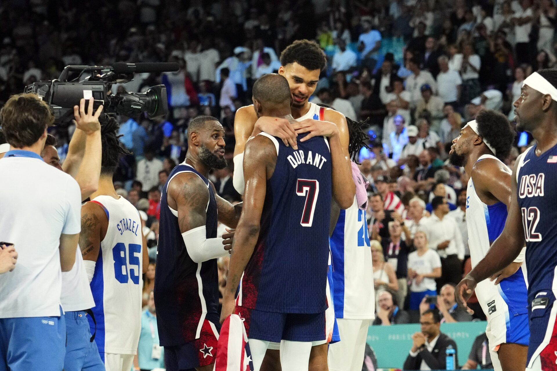 United States guard Kevin Durant (7) embraces France power forward Victor Wembanyama (32) after the men's basketball gold medal game during the Paris 2024 Olympic Summer Games at Accor Arena.