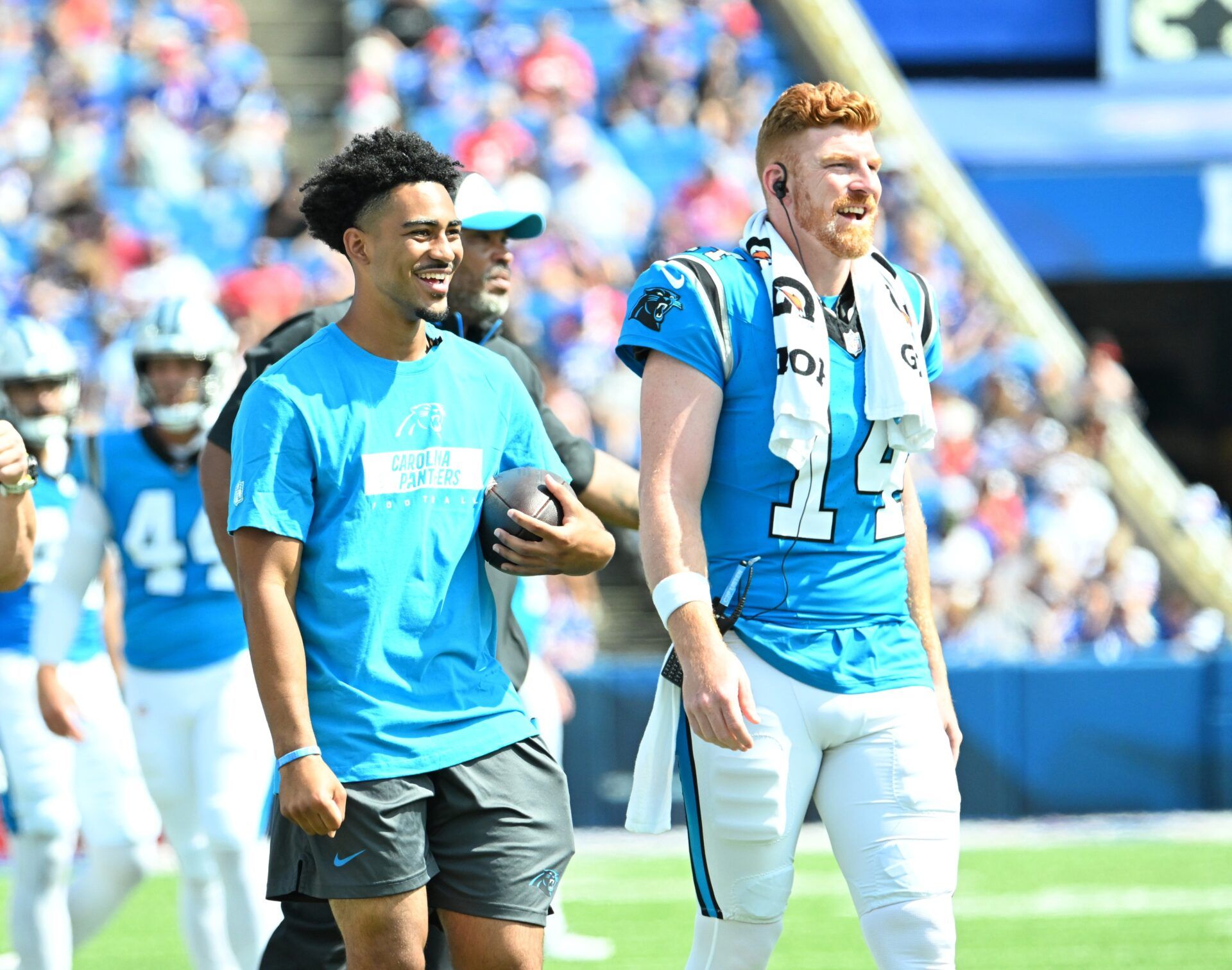 Carolina Panthers quarterback Bryce Young and quarterback Andy Dalton (14) react to their team scoring a touchdown against the Buffalo Bills in the third quarter pre-season game at Highmark Stadium.