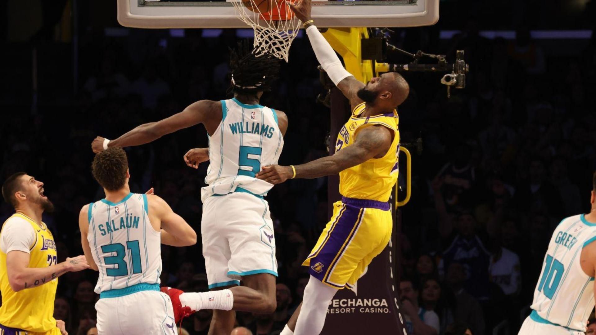 Lakers superstar LeBron James threw down a monster dunk on Hornets center Mark Williams, and his son, Bronny, was blown away.