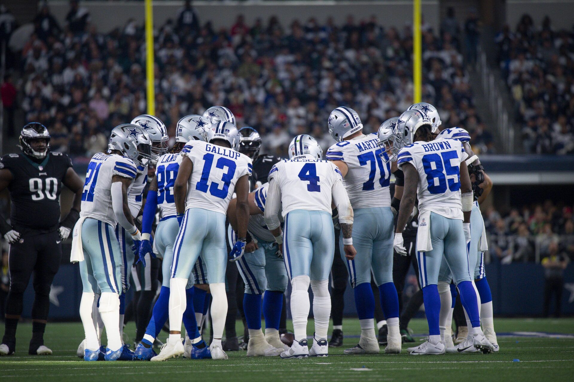 Dallas Cowboys running back Ezekiel Elliott (21) and wide receiver CeeDee Lamb (88) and wide receiver Michael Gallup (13) and quarterback Dak Prescott (4) and guard Zack Martin (70) and wide receiver Noah Brown (85) in the huddle during the game between the Dallas Cowboys and the Philadelphia Eagles at AT&T Stadium.