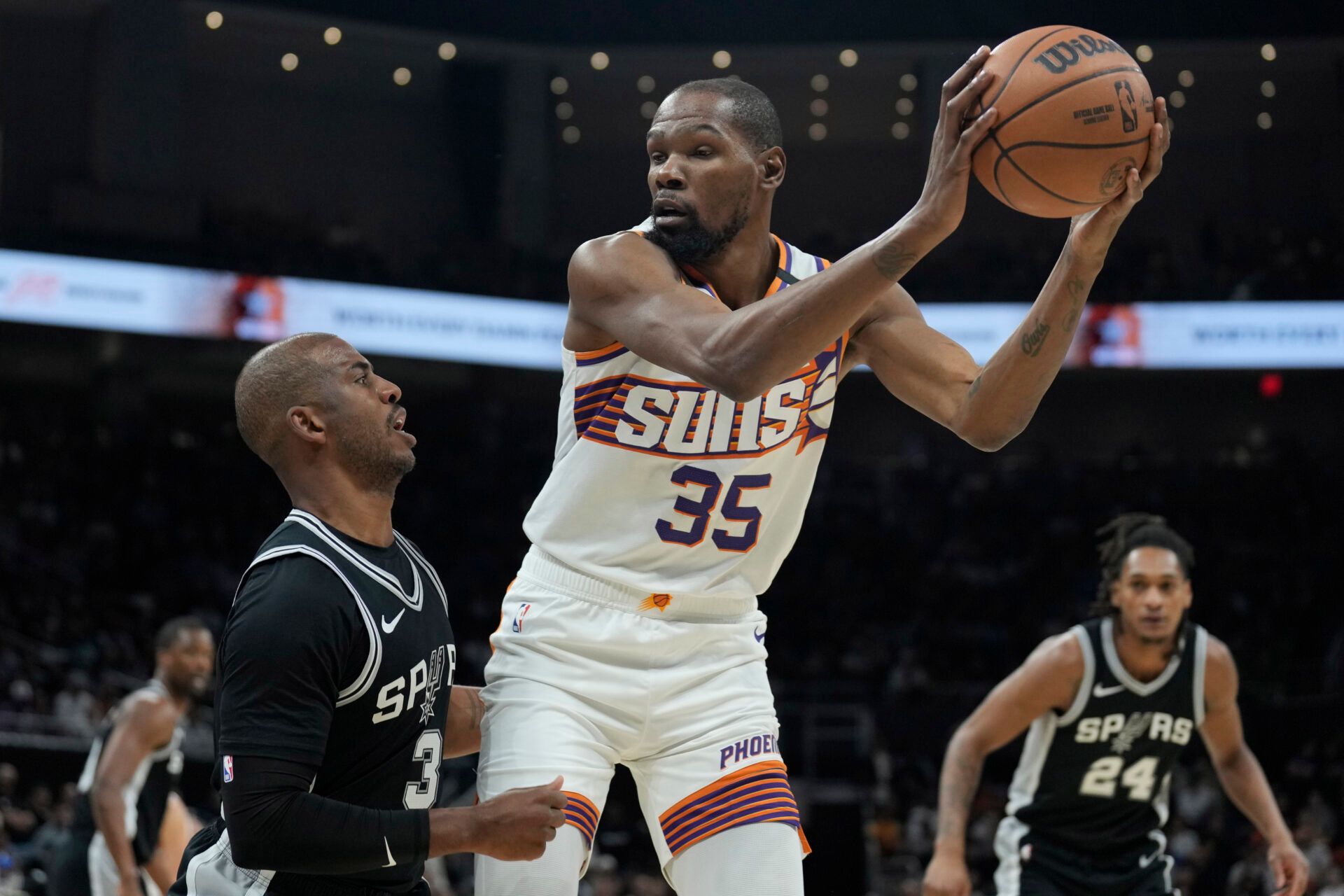 Feb 20, 2025; Austin, Texas, USA; Phoenix Suns forward Kevin Durant (35) looks to drive to the basket while defended by San Antonio Spurs guard Chris Paul (3) during the first half at Moody Center. Mandatory Credit: Scott Wachter-Imagn Images