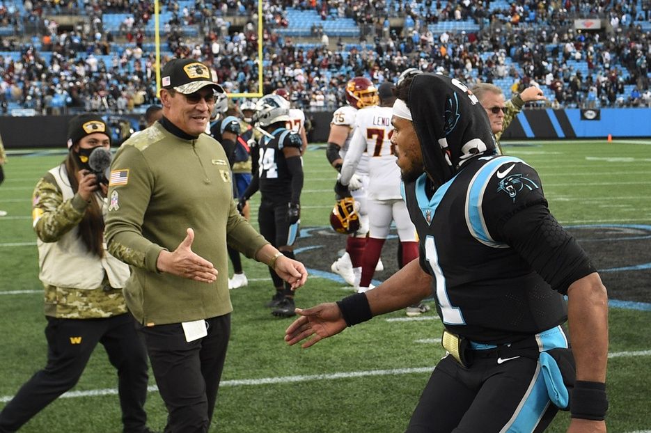 Washington Football Team head coach Ron Rivera with Carolina Panthers quarterback Cam Newton (1) after the game at Bank of America Stadium.