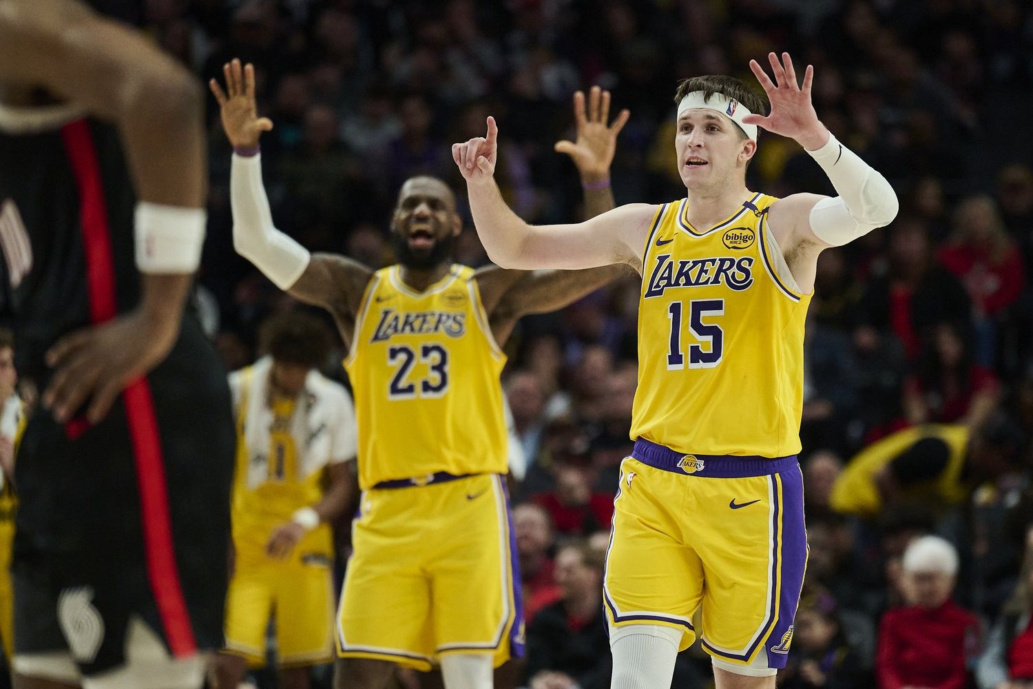 Los Angeles Lakers guard Austin Reaves (15) and forward LeBron James (23) signal to teammates during the second half against the Portland Trail Blazers at Moda Center.