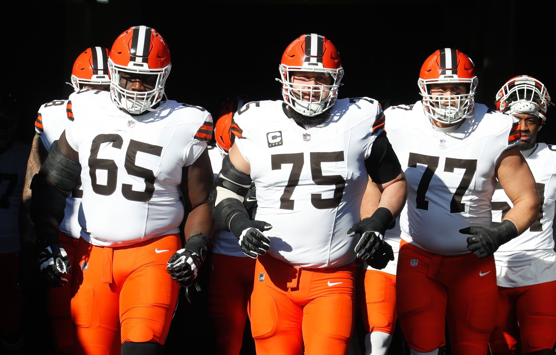 Cleveland Browns guards Germain Ifedi (65) and Joel Bitonio (75) and Wyatt Teller (77) take the field to play the Pittsburgh Steelers at Acrisure Stadium.