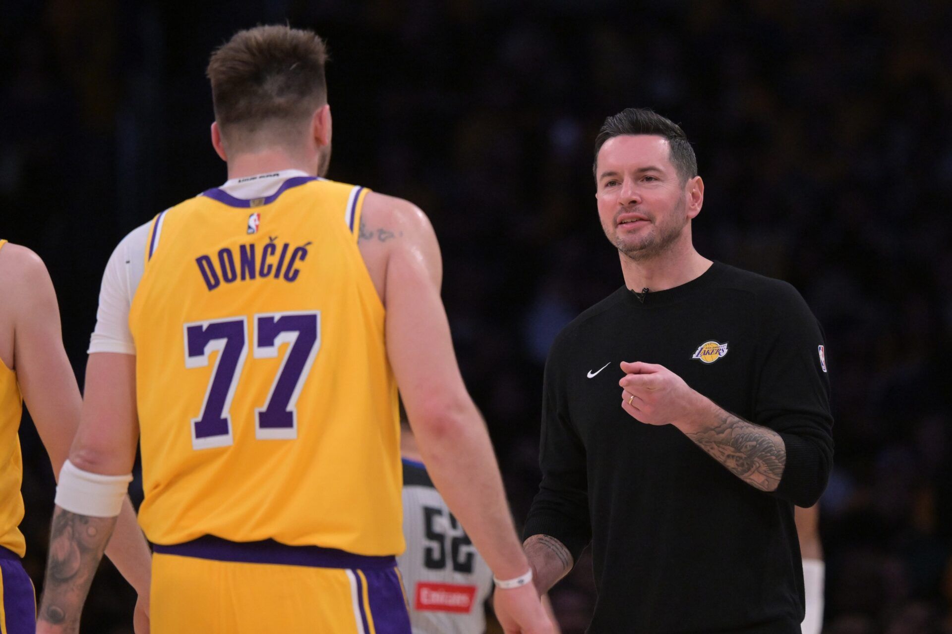 Los Angeles Lakers guard Luka Doncic (77) is greeted by head coach JJ Redick during a time out against the Utah Jazz at Crypto.com Arena.