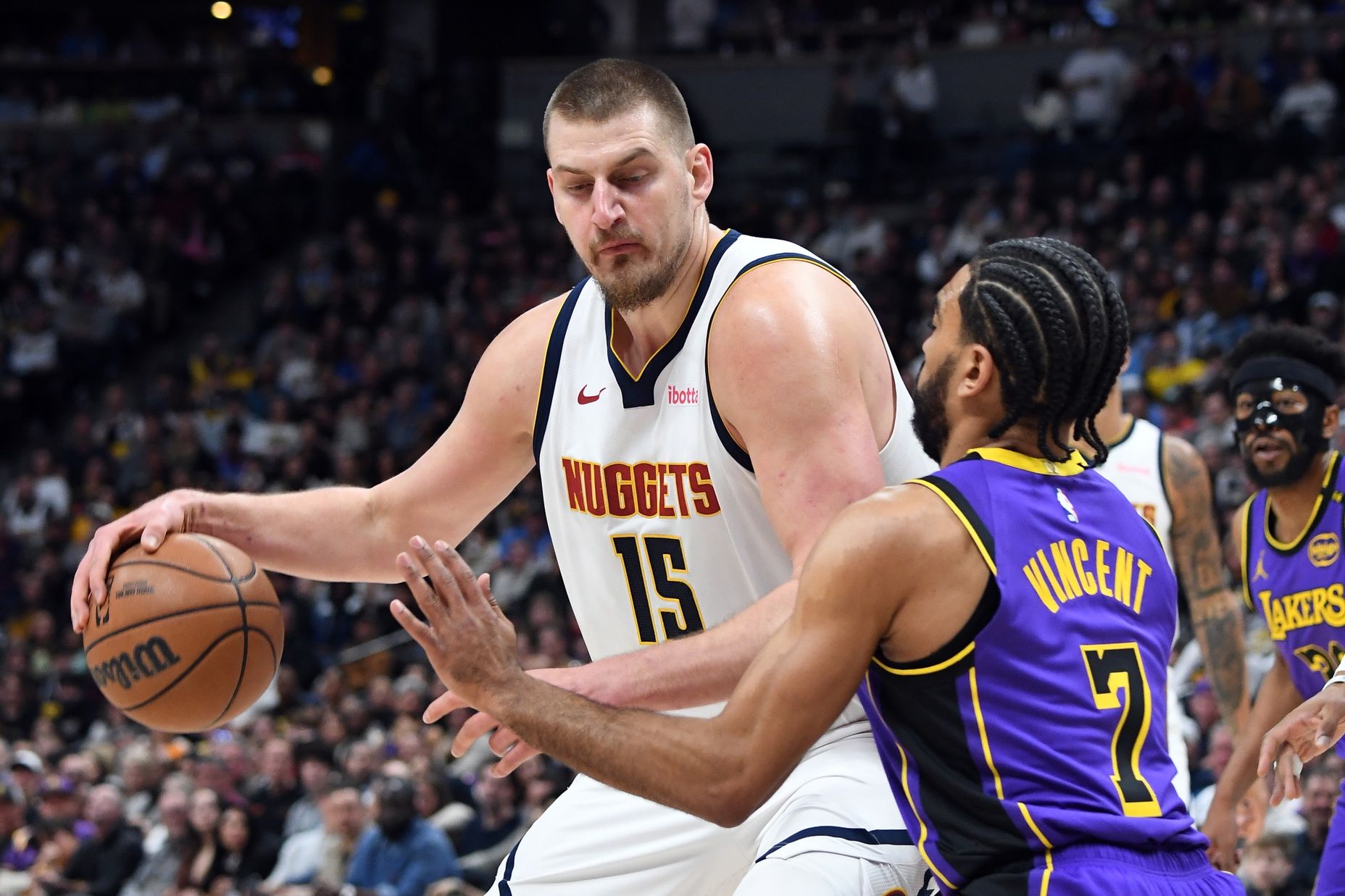 Denver Nuggets center Nikola Jokic (15) works in the post against Los Angeles Lakers guard Gabe Vincent (7) during the first half at Ball Arena.