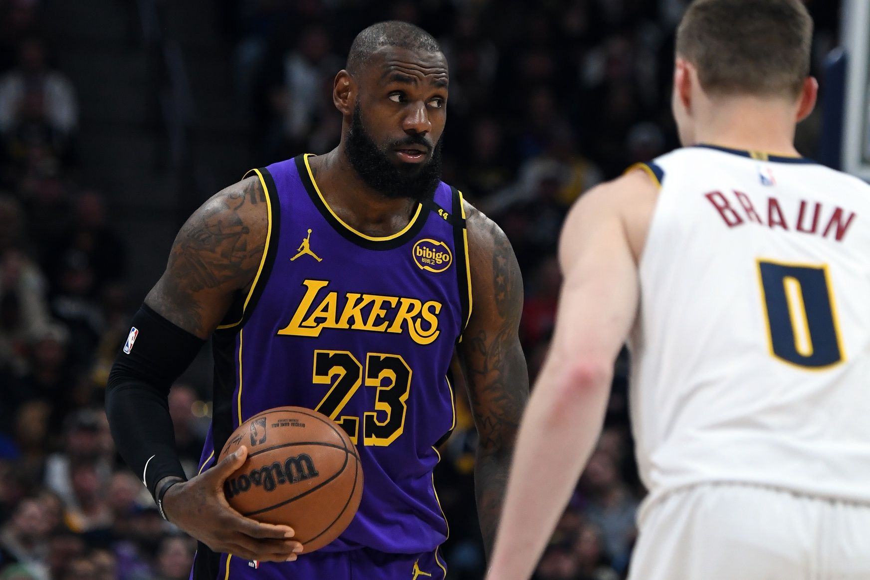 Los Angeles Lakers forward LeBron James (23) holds the ball during the second half against the Denver Nuggets at Ball Arena.