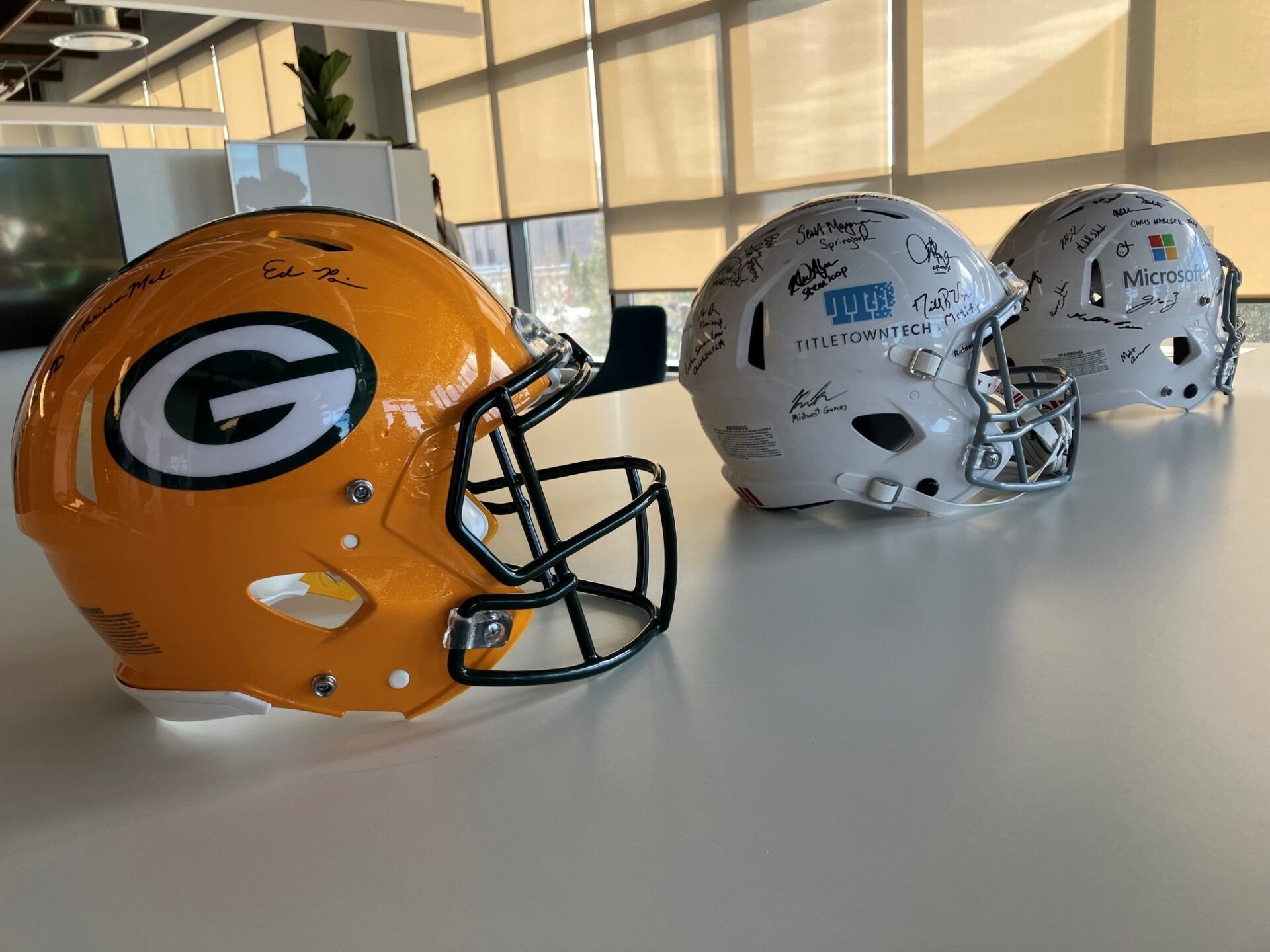 Football helmets signed by employees of the Green Bay Packers, TitletownTech and Microsoft on display in the TitletownTech offices. The venture capital studio plans to host a $1 million Startup Draft pitch contest during the NFL draft in Green Bay.