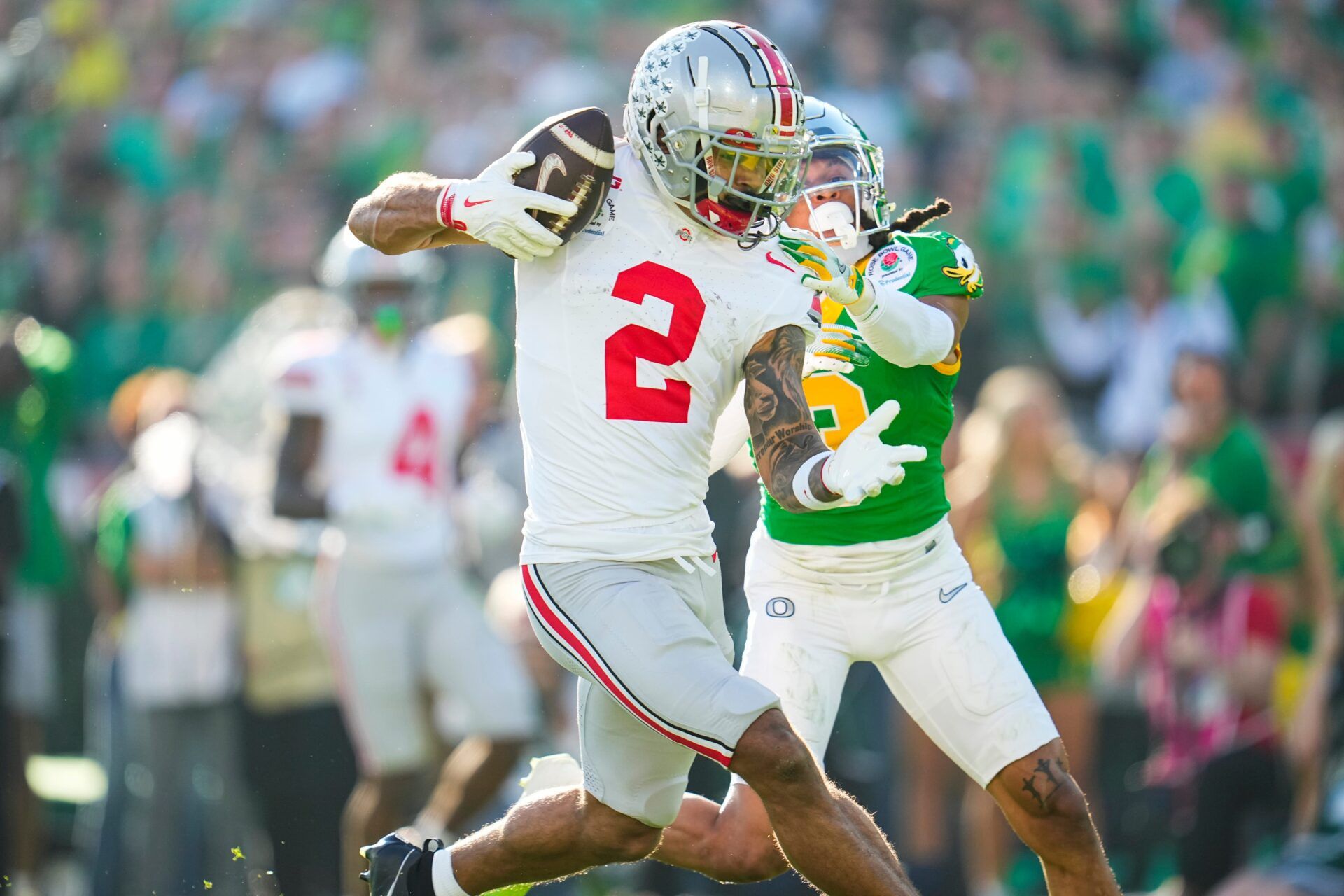 Ohio State Buckeyes wide receiver Emeka Egbuka (2) catches a touchdown in front of Oregon Ducks defensive back Brandon Johnson (3) during the first half of the College Football Playoff quarterfinal at the Rose Bowl in Pasadena, Calif. on Jan. 1, 2025.