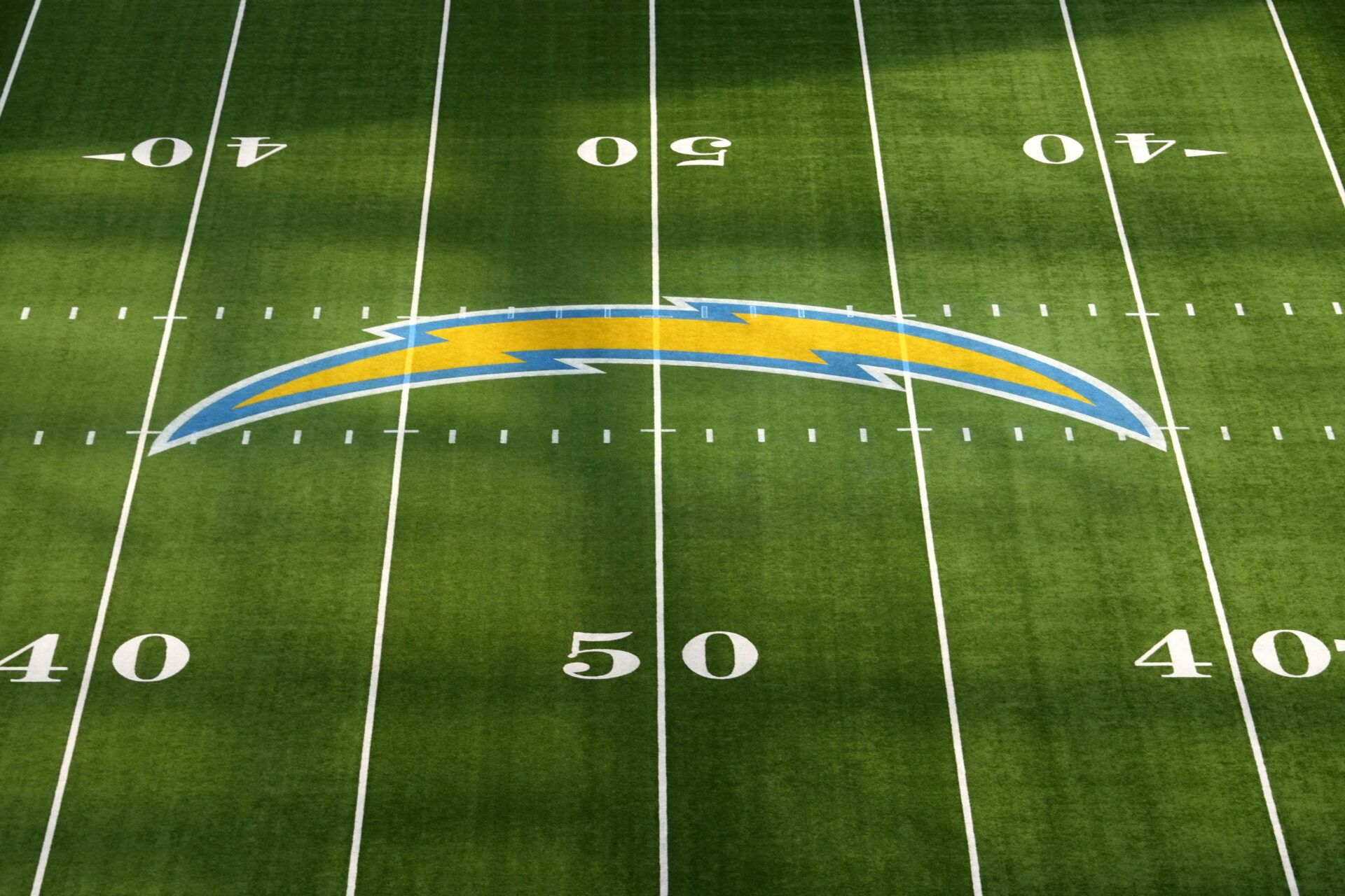 Nov 17, 2024; Inglewood, California, USA; The Los Angeles Chargers bolt logo at midfield before the game against the Cincinnati Bengals at SoFi Stadium. Mandatory Credit: Kirby Lee-Imagn Images