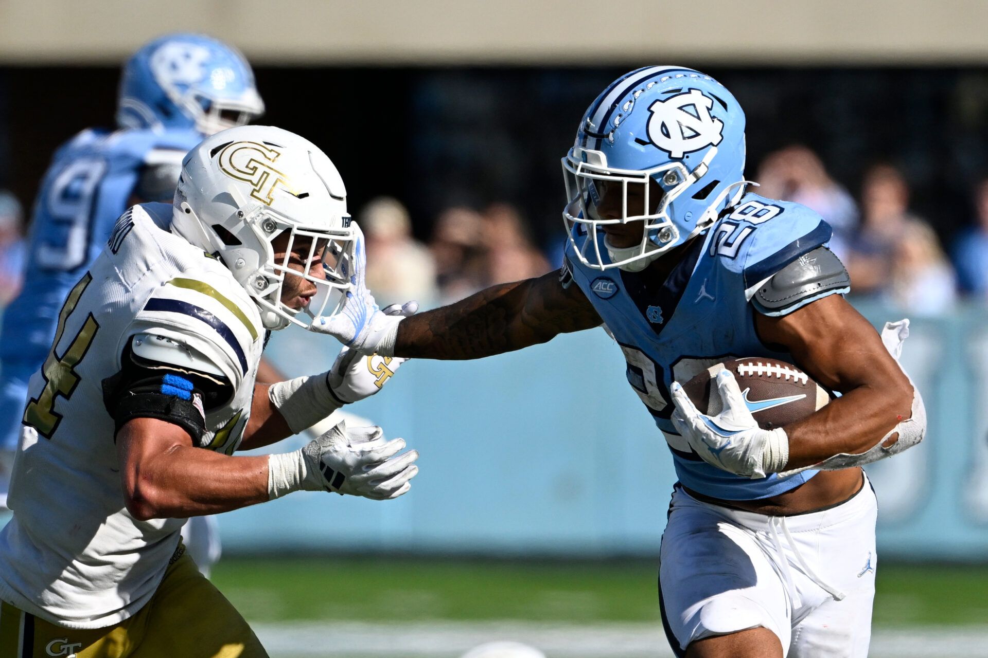 Oct 12, 2024; Chapel Hill, North Carolina, USA; North Carolina Tar Heels running back Omarion Hampton (28) with the ball as Georgia Tech Yellow Jackets linebacker Kyle Efford (44) defends in the fourth quarter at Kenan Memorial Stadium. Mandatory Credit: Bob Donnan-Imagn Images