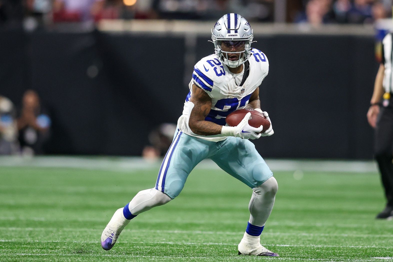 Dallas Cowboys running back Rico Dowdle (23) runs after a catch against the Atlanta Falcons in the fourth quarter at Mercedes-Benz Stadium.