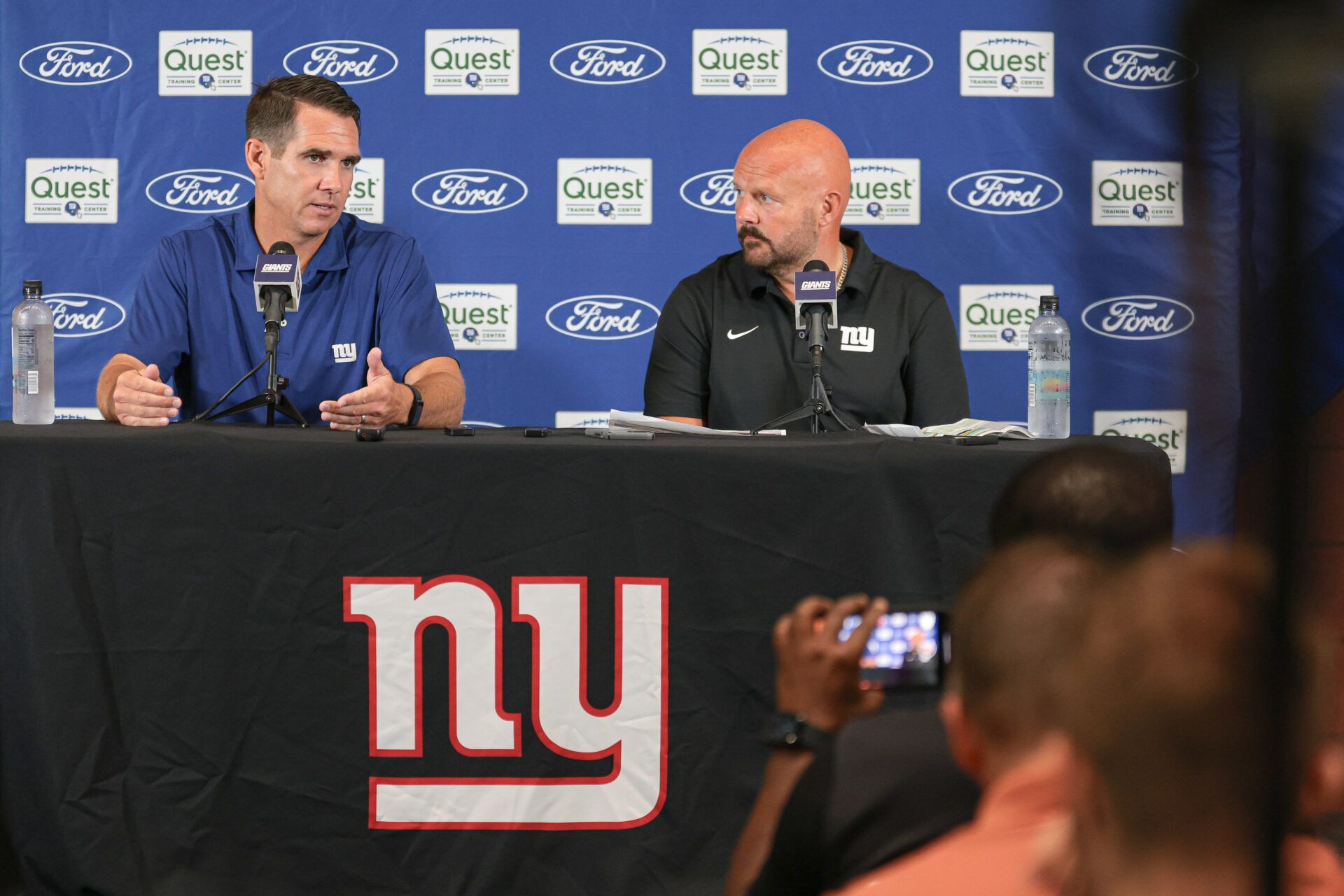 Jul 24, 2024; East Rutherford, NJ, USA; New York Giants general manager Joe Schoen (left) and head coach Brian Dabol talks to media before the start of training camp at Quest Diagnostics Training Facility. Mandatory Credit: Vincent Carchietta-USA TODAY Sports