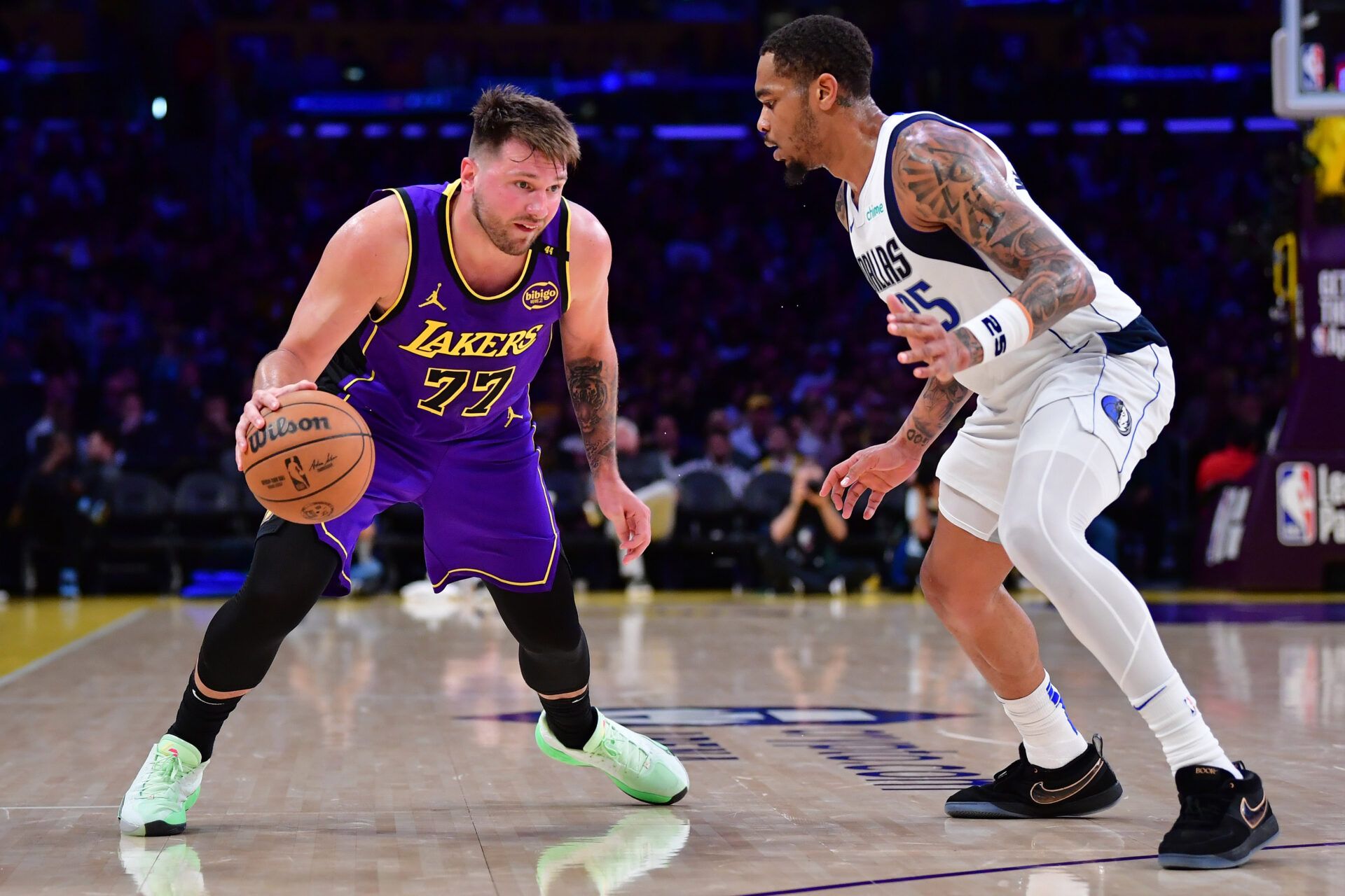 Feb 25, 2025; Los Angeles, California, USA; Los Angeles Lakers guard Luka Doncic (77) dribbles the ball against Dallas Mavericks forward P.J. Washington (25) during the second half at Crypto.com Arena. Mandatory Credit: Gary A. Vasquez-Imagn Images