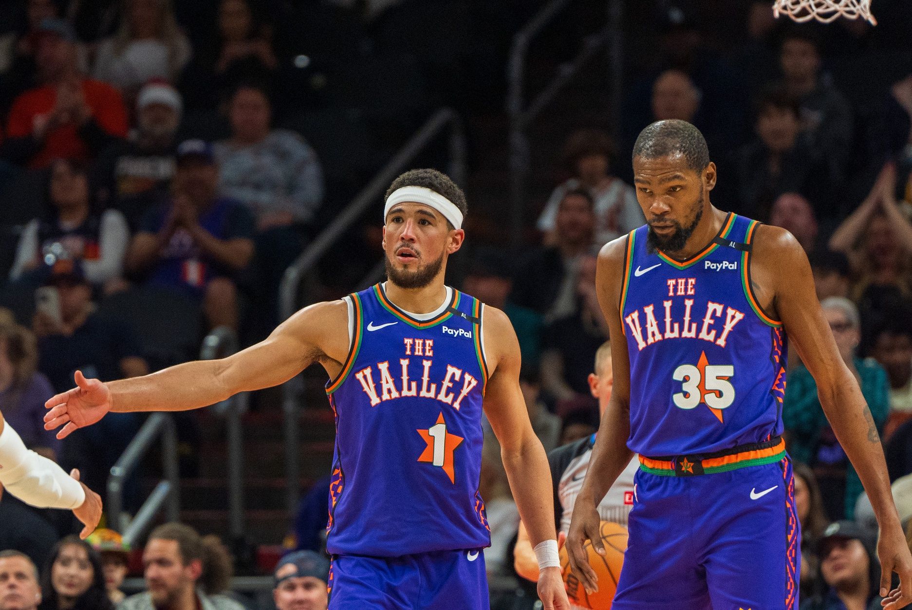 Phoenix Suns guard Devin Booker (1) and forward Kevin Durant (35) react after a time out in the second half during a game against the Portland Trail Blazers at Footprint Center.